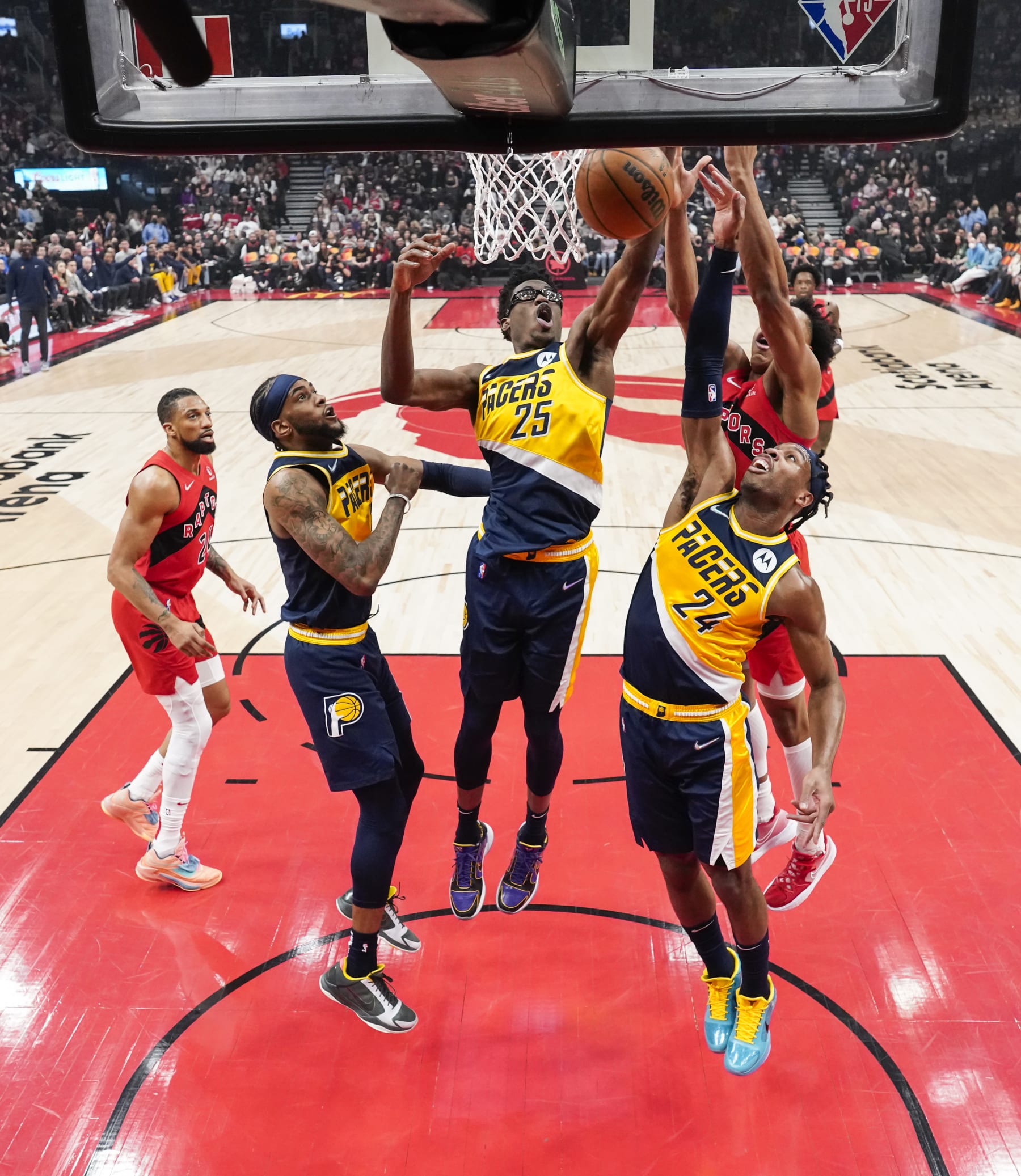 TORONTO, ON - MARCH 26: Jalen Smith #25, Buddy Hield #24, and Oshae Brissett #12 of the Indiana Pacers battle for a rebound against Scottie Barnes #4 and Khem Birch #24 of the Toronto Raptors during the first half of their basketball game at the Scotiabank Arena on March 26, 2022 in Toronto, Ontario, Canada. NOTE TO USER: User expressly acknowledges and agrees that, by downloading and/or using this Photograph, user is consenting to the terms and conditions of the Getty Images License Agreement. (Photo by Mark Blinch/Getty Images)