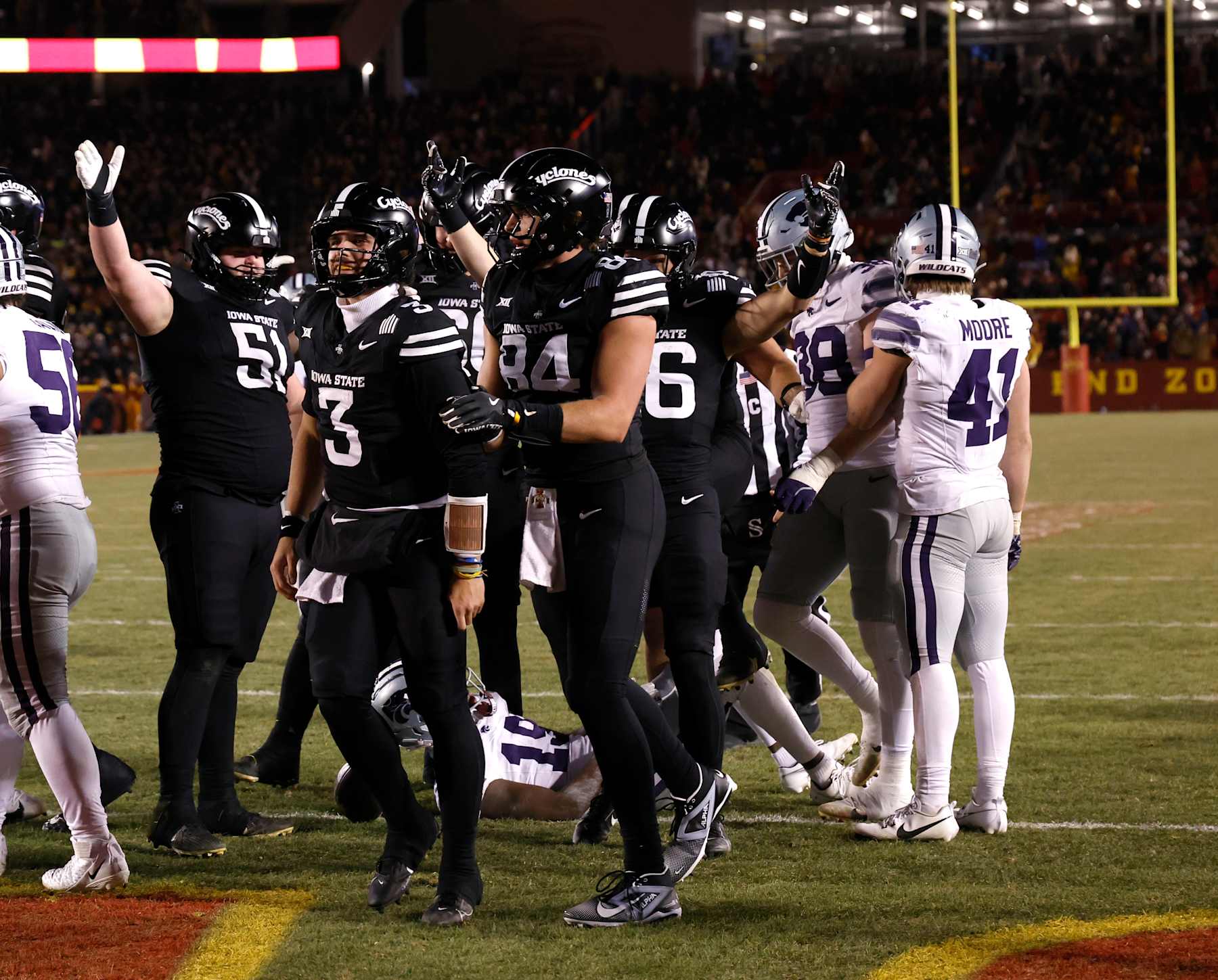 AMES, IA - NOVEMBER 30: Quarterback Rocco Becht #3 of the Iowa State Cyclones celebrates with teammates offensive lineman Brendan Black #51, and tight end Gabe Burkle #84 of the Iowa State Cyclones after scoring a touchdown in the first half of play at Jack Trice Stadium on November 30, 2024, in Ames, Iowa. (Photo by David Purdy/Getty Images)