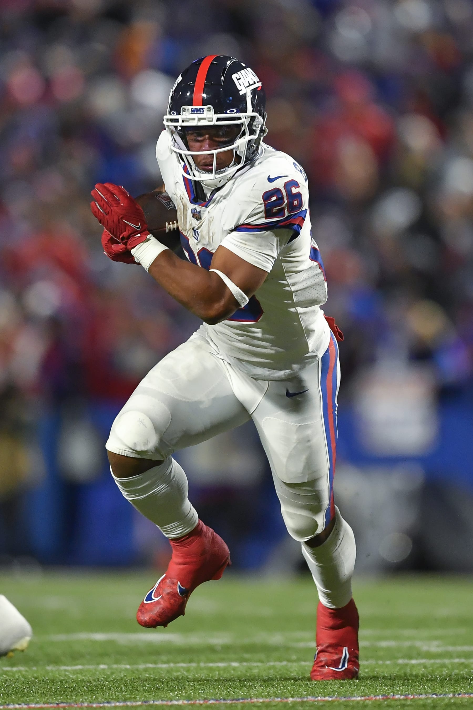 New York Giants running back Saquon Barkley (26) runs with the ball during the second half of an NFL football game against the Buffalo Bills in Orchard Park, N.Y., Sunday, Oct. 15, 2023. (AP Photo/Adrian Kraus)
