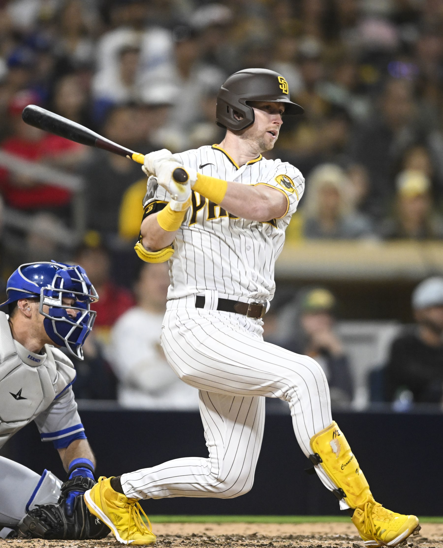 SAN DIEGO, CA - MAY 16:  Jake Cronenworth #9 of the San Diego Padres hits an RBI single during the fifth inning of a baseball game against the Kansas City Royals May 16 2023 at Petco Park in San Diego, California. (Photo by Denis Poroy/Getty Images)