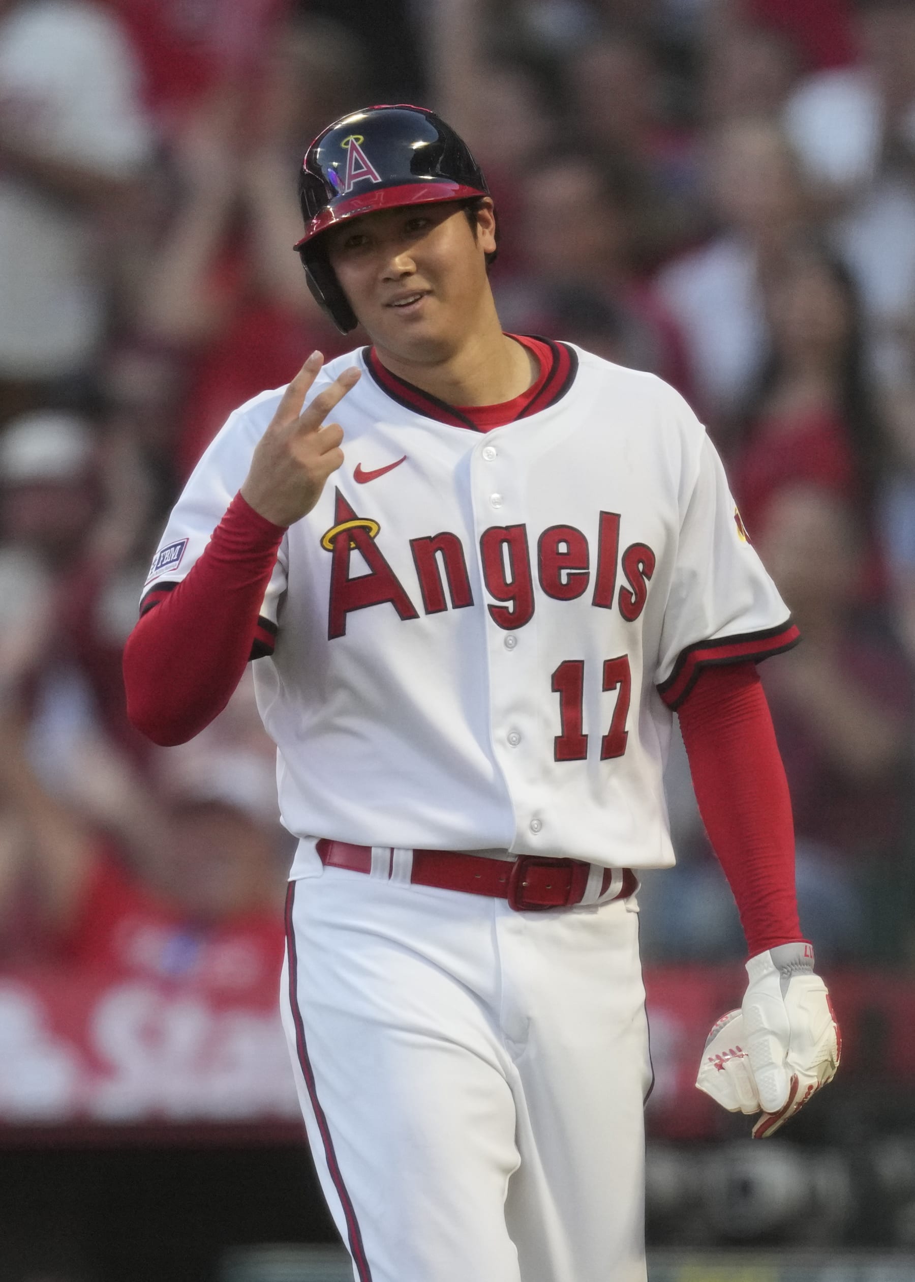 Los Angeles Angels starting pitcher Shohei Ohtani (17) reacts after scoring off of a double hit by Mickey Moniak during the fourth inning of a baseball game against the Pittsburgh Pirates in Anaheim, Calif., Friday, July 21, 2023. (AP Photo/Ashley Landis)