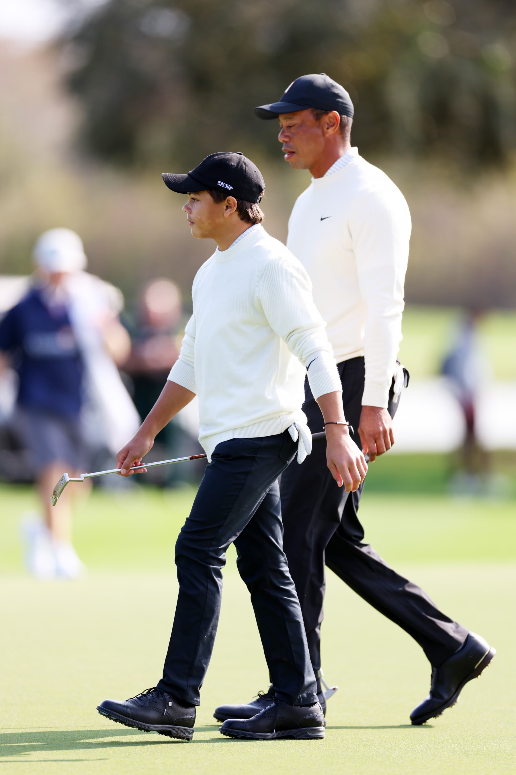 ORLANDO, FLORIDA - DECEMBER 16:  Charlie Woods and Tiger Woods of the United States walk on the 11th green during the pro-am prior to the PNC Championship at Ritz-Carlton Golf Club on December 16, 2022 in Orlando, Florida. (Photo by Mike Ehrmann/Getty Images)