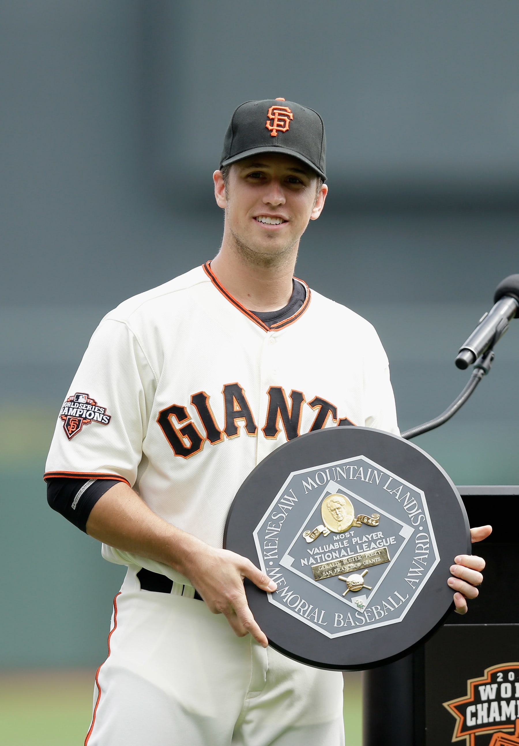 SAN FRANCISCO, CA - APRIL 06:  Buster Posey #28 of the San Francisco Giants holds the 2012 National League MVP Award during a pregame ceremony honoring him before the Giants game against the St. Louis Cardinals at AT&T Park on April 6, 2013 in San Francisco, California.  (Photo by Ezra Shaw/Getty Images)