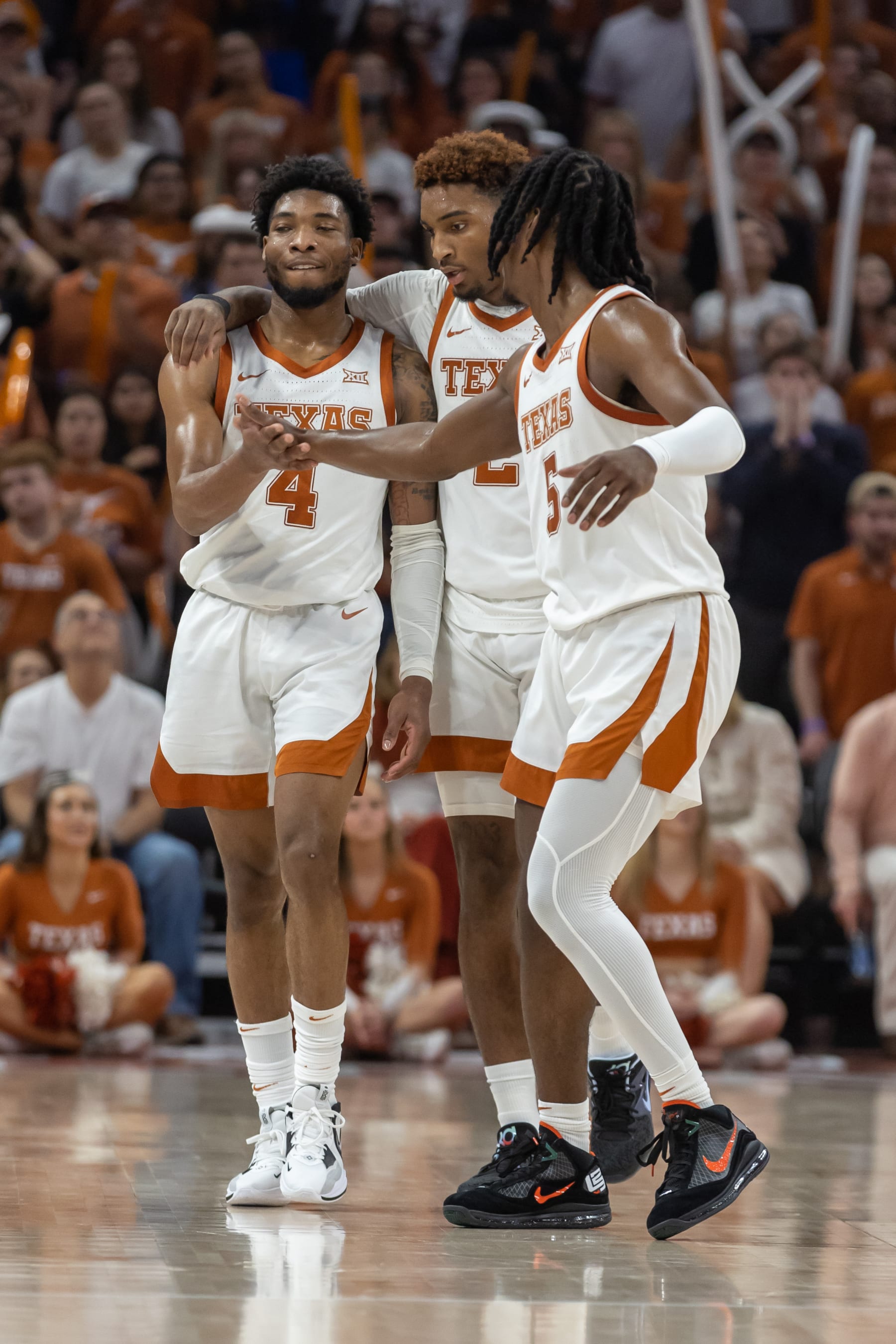 AUSTIN, TX - FEBRUARY 21: Texas Longhorns guard Tyrese Hunter (4) is approached by Texas Longhorns guard Arterio Morris (2) and Texas Longhorns guard Marcus Carr (5) after taking a hard fall to the floor during the Big 12 basketball game between Texas Longhorns and Iowa State Cyclones on February 21, 2023, at Moody Center in Austin, TX. (Photo by David Buono/Icon Sportswire via Getty Images)