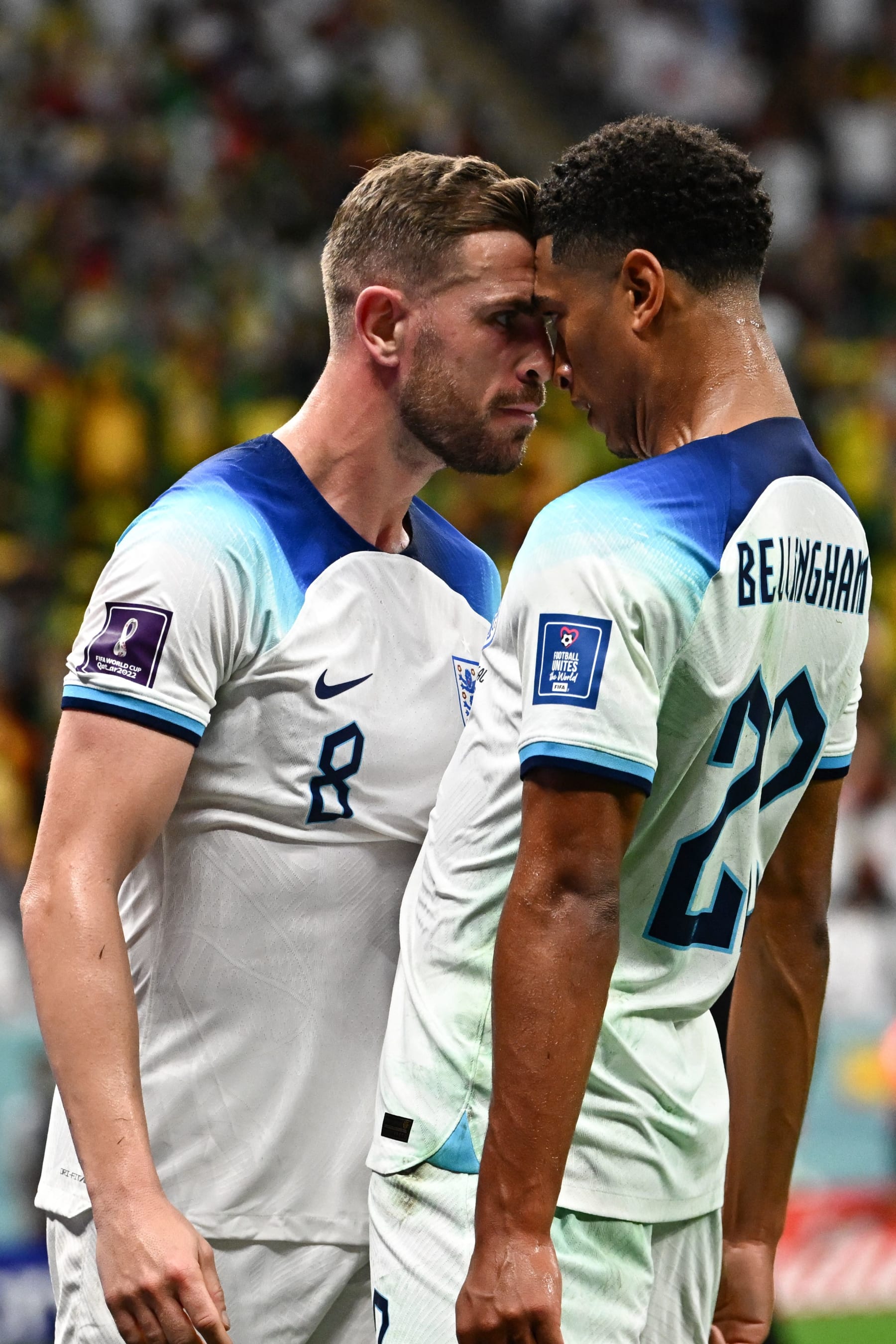 England's midfielder #08 Jordan Henderson (L) celebrates with England's midfielder #22 Jude Bellingham after he scored his team's first goal during the Qatar 2022 World Cup round of 16 football match between England and Senegal at the Al-Bayt Stadium in Al Khor, north of Doha on December 4, 2022. (Photo by Anne-Christine POUJOULAT / AFP) (Photo by ANNE-CHRISTINE POUJOULAT/AFP via Getty Images)