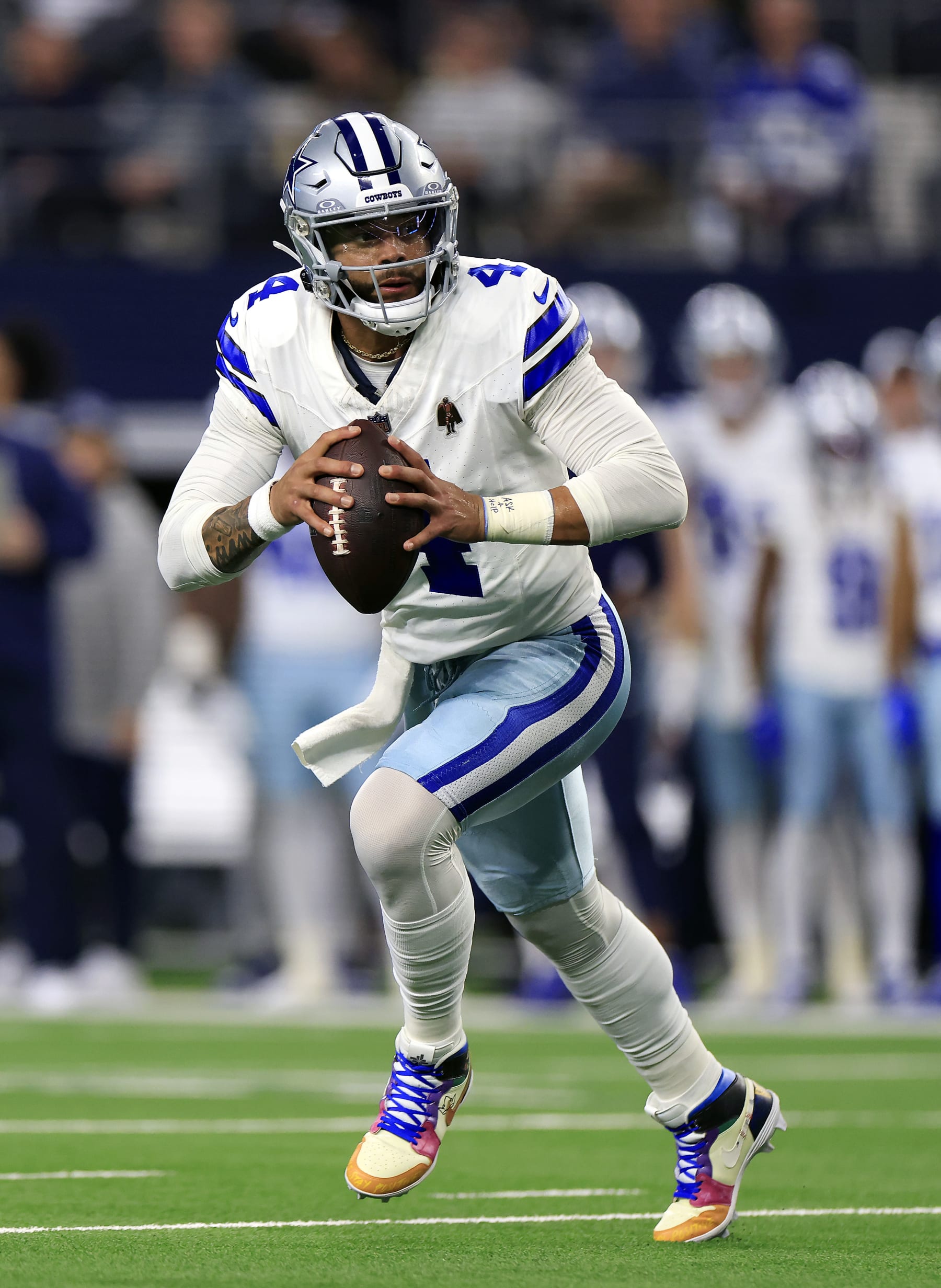 ARLINGTON, TEXAS - NOVEMBER 30:  Quarterback Dak Prescott #4 of the Dallas Cowboys scrambles during the 1st quarter of the game against the Seattle Seahawks at AT&T Stadium on November 30, 2023 in Arlington, Texas. (Photo by Ron Jenkins/Getty Images)