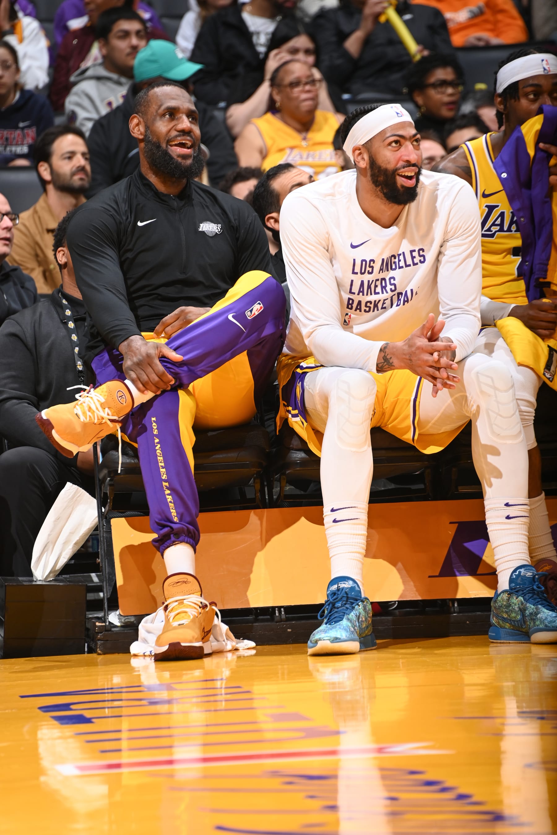 LOS ANGELES, CA - JANUARY 17:  LeBron James #23 of the Los Angeles Lakers  Anthony Davis #3 of the Los Angeles Lakers smile and look on during the game on January 17, 2024 at Crypto.Com Arena in Los Angeles, California. NOTE TO USER: User expressly acknowledges and agrees that, by downloading and/or using this Photograph, user is consenting to the terms and conditions of the Getty Images License Agreement. Mandatory Copyright Notice: Copyright 2024 NBAE (Photo by Andrew D. Bernstein/NBAE via Getty Images)