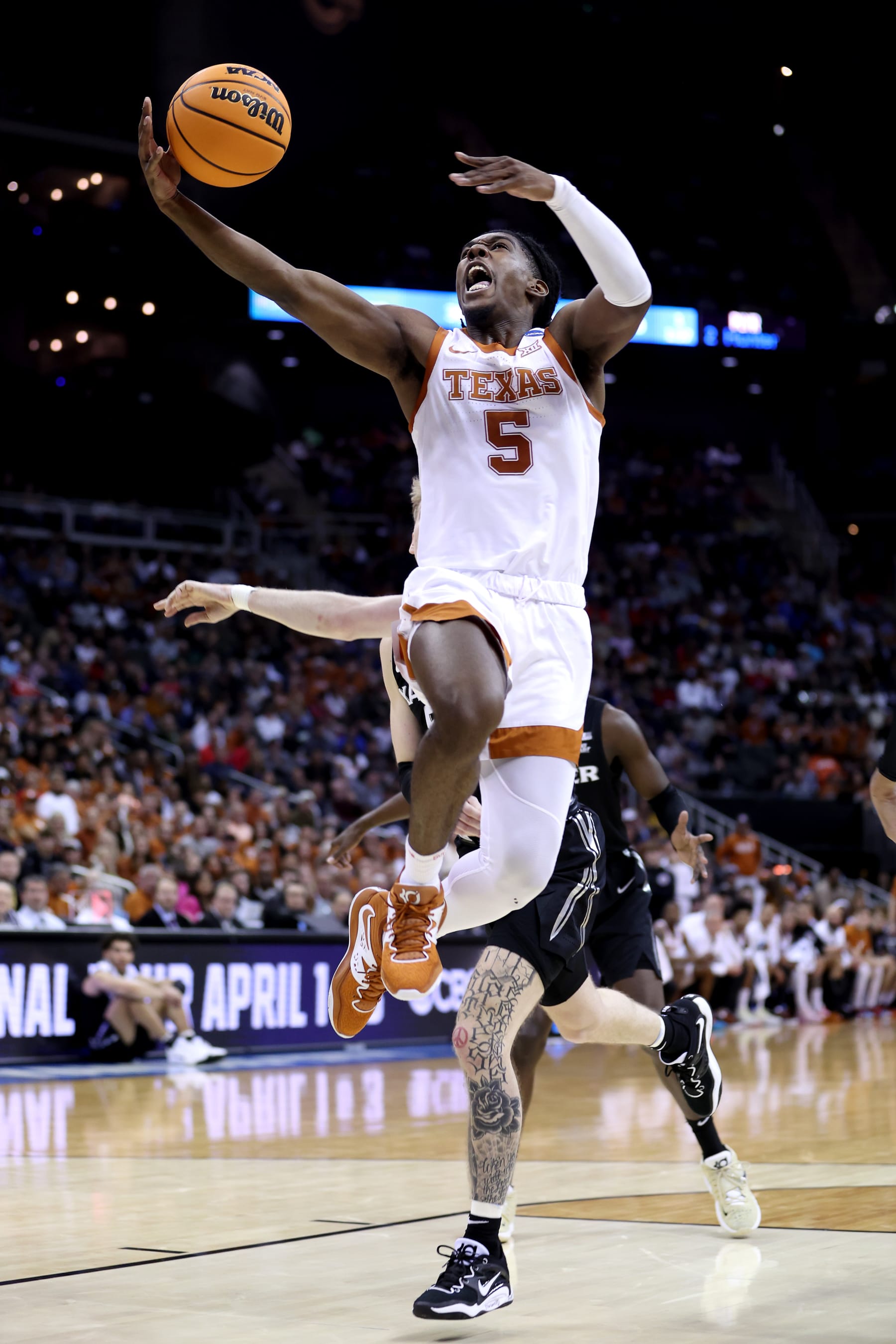 KANSAS CITY, MISSOURI - MARCH 24: Marcus Carr #5 of the Texas Longhorns attempts a layup against the Xavier Musketeers during the first half in the Sweet 16 round of the NCAA Men's Basketball Tournament at T-Mobile Center on March 24, 2023 in Kansas City, Missouri. (Photo by Gregory Shamus/Getty Images)