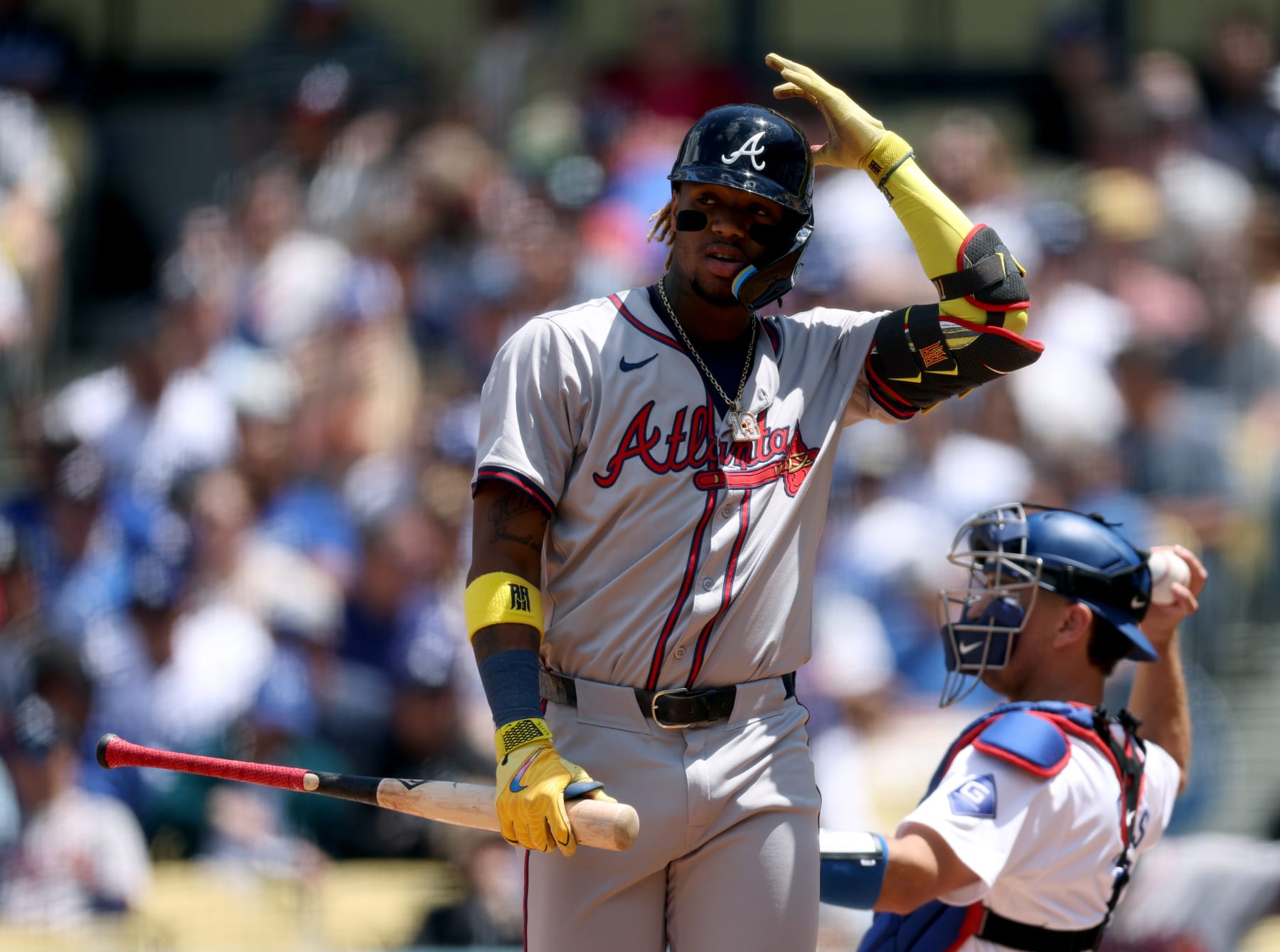 LOS ANGELES, CALIFORNIA - MAY 05: Ronald Acuña Jr. #13 of the Atlanta Braves react at bat in front of Will Smith #16 of the Los Angeles Dodgers during a 5-1 loss at Dodger Stadium on May 05, 2024 in Los Angeles, California. (Photo by Harry How/Getty Images)