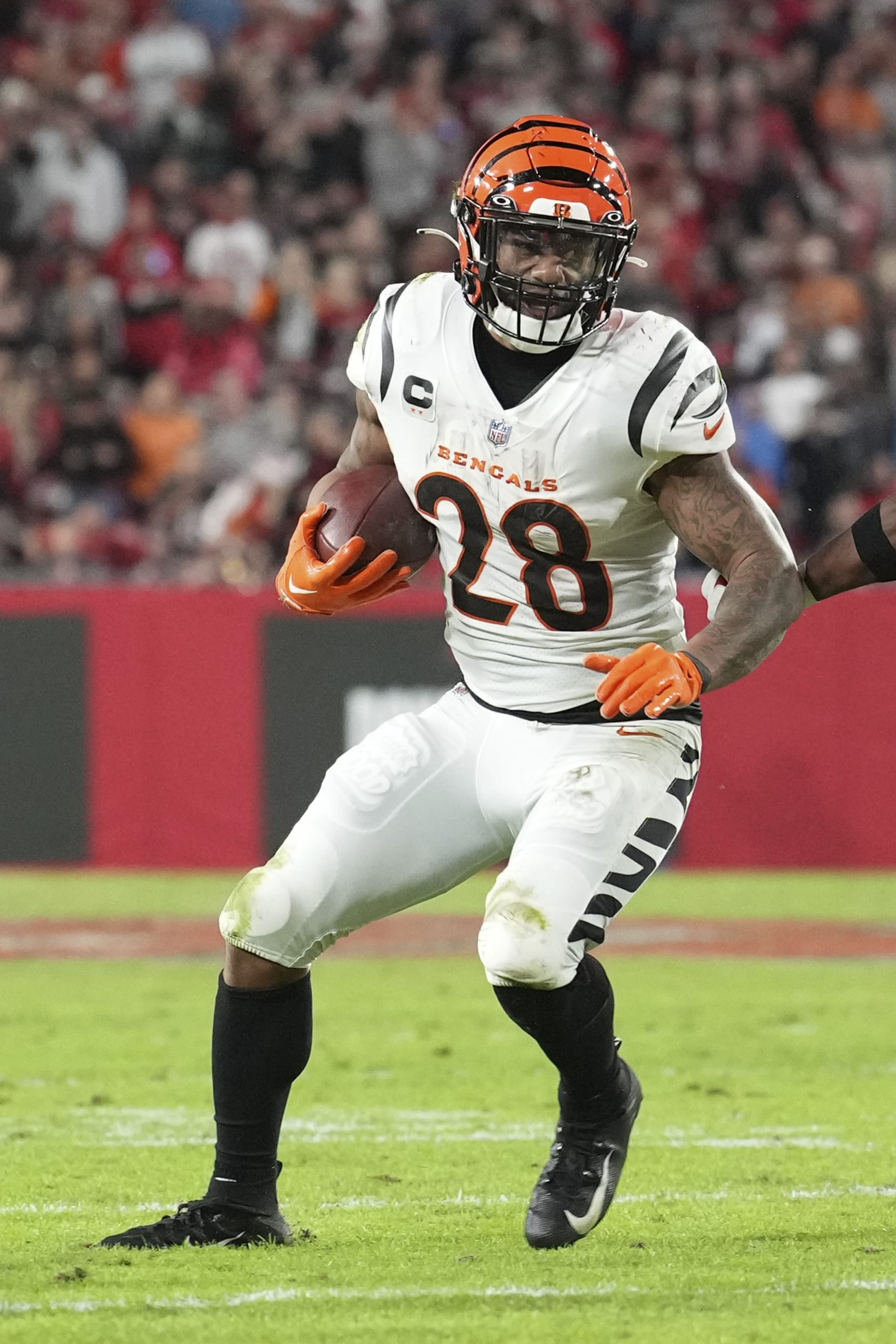 Cincinnati Bengals running back Joe Mixon (28) eyes a defender as he rushes with the ball during an NFL football game against the Tampa Bay Buccaneers, Sunday, Dec. 18, 2022, in Tampa, Fla. (AP Photo/Peter Joneleit)