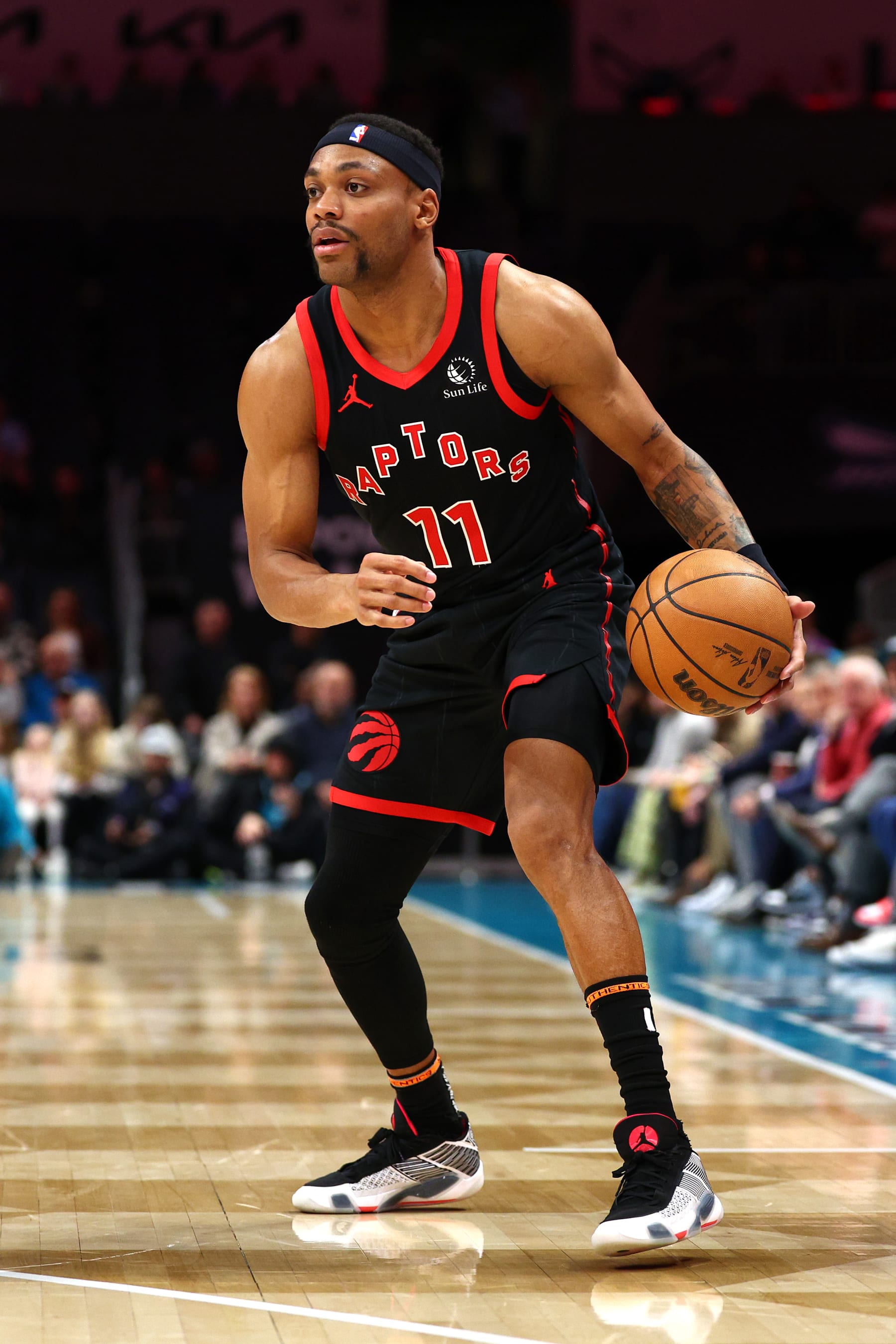 CHARLOTTE, NORTH CAROLINA - FEBRUARY 07: Bruce Brown #11 of the Toronto Raptors dribbles during the first half of the game against the Charlotte Hornets at Spectrum Center on February 07, 2024 in Charlotte, North Carolina. NOTE TO USER: User expressly acknowledges and agrees that, by downloading and or using this photograph, User is consenting to the terms and conditions of the Getty Images License Agreement. (Photo by Jared C. Tilton/Getty Images)