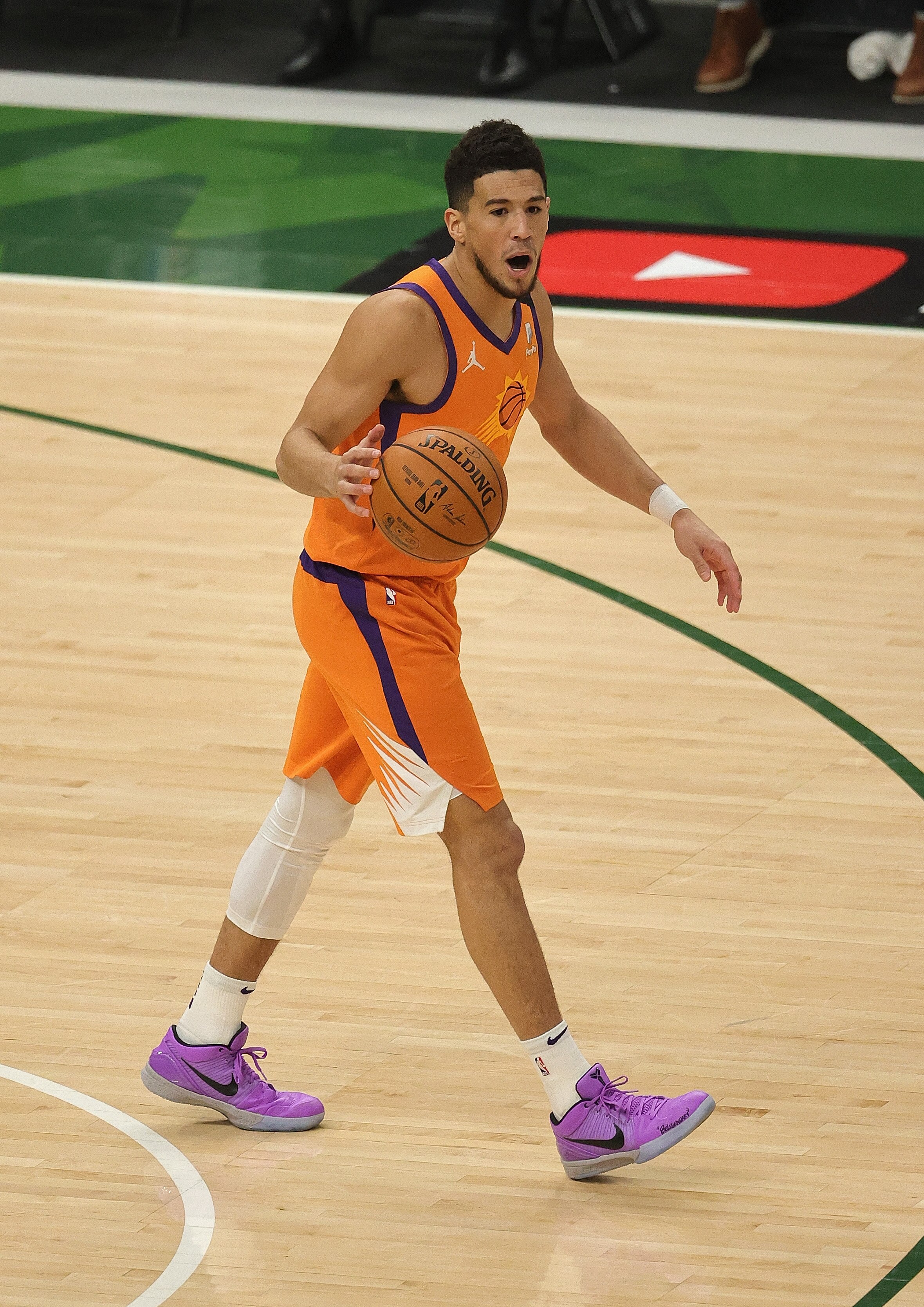 MILWAUKEE, WISCONSIN - JULY 20: Devin Booker #1 of the Phoenix Suns brings the ball up the court against the Milwaukee Bucks at Fiserv Forum on July 20, 2021 in Milwaukee, Wisconsin. The Bucks defeated the Suns 105-98. NOTE TO USER: User expressly acknowledges and agrees that, by downloading and or using this photograph, User is consenting to the terms and conditions of the Getty Images License Agreement. (Photo by Jonathan Daniel/Getty Images)