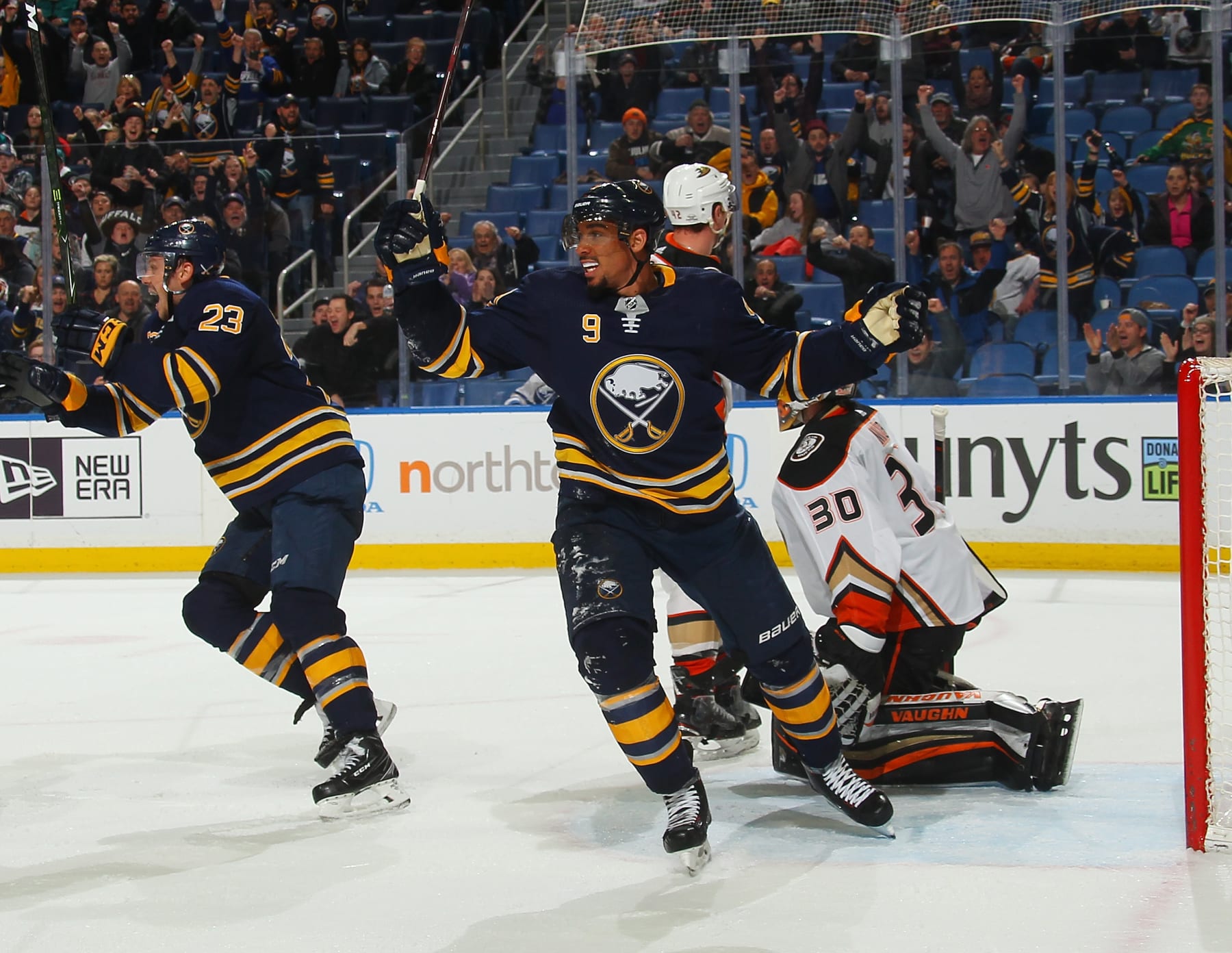 BUFFALO, NY - FEBRUARY 6: Evander Kane #9 and Sam Reinhart #23 of the Buffalo Sabres react as Ryan O'Reilly (not shown) scores a late third period goal against Ryan Miller #30 of the Anaheim Ducks to tie an NHL game on February 6, 2018 at KeyBank Center in Buffalo, New York. Anaheim won in overtime, 4-3. (Photo by Bill Wippert/NHLI via Getty Images) 