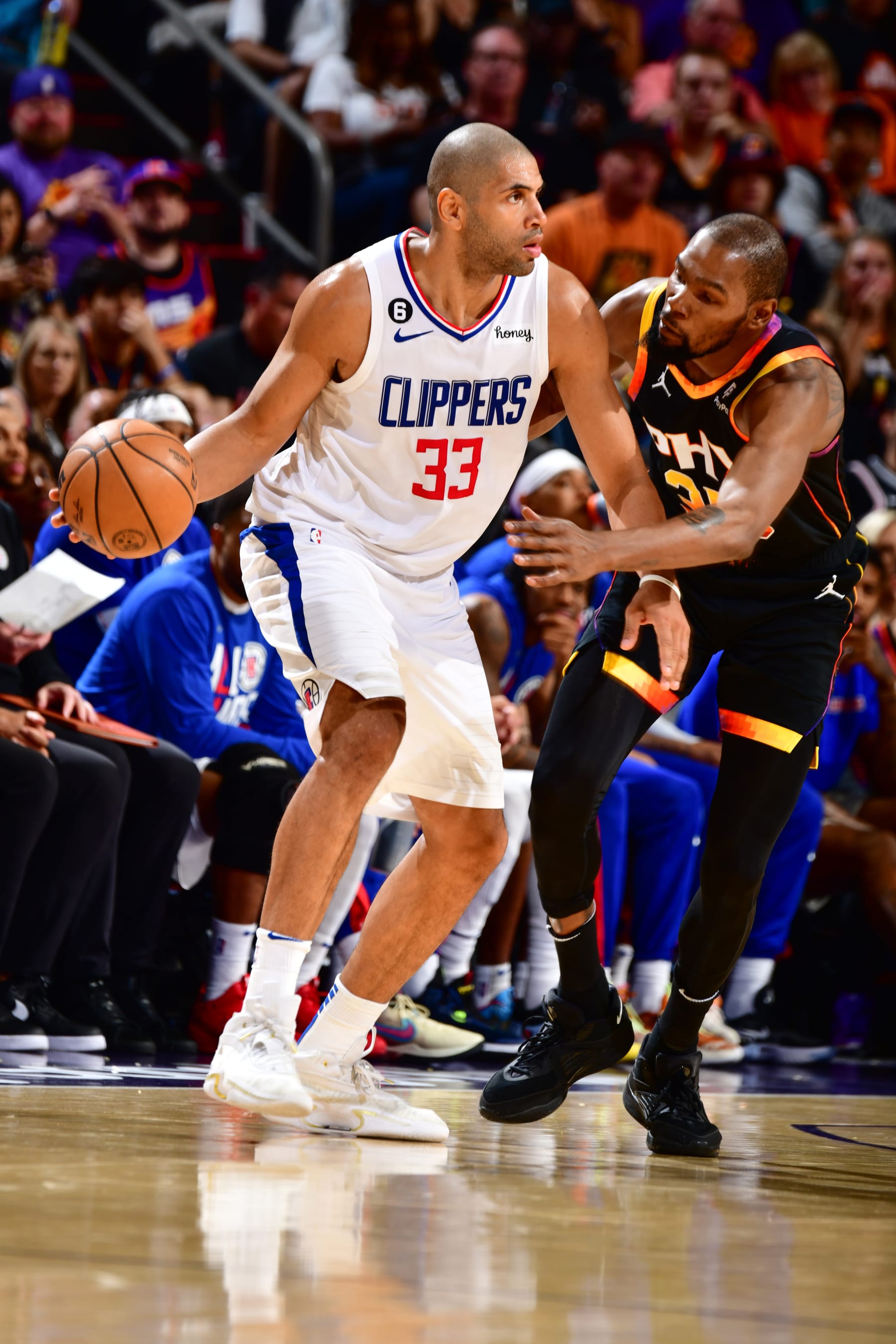 PHOENIX, AZ - APRIL 16:  Nicolas Batum #33 of the LA Clippers handles the ball during the game  During round one game one of the 2023 NBA Playoffs on April 16, 2023 at Footprint Center in Phoenix, Arizona. NOTE TO USER: User expressly acknowledges and agrees that, by downloading and or using this photograph, user is consenting to the terms and conditions of the Getty Images License Agreement. Mandatory Copyright Notice: Copyright 2023 NBAE (Photo by Barry Gossage/NBAE via Getty Images)