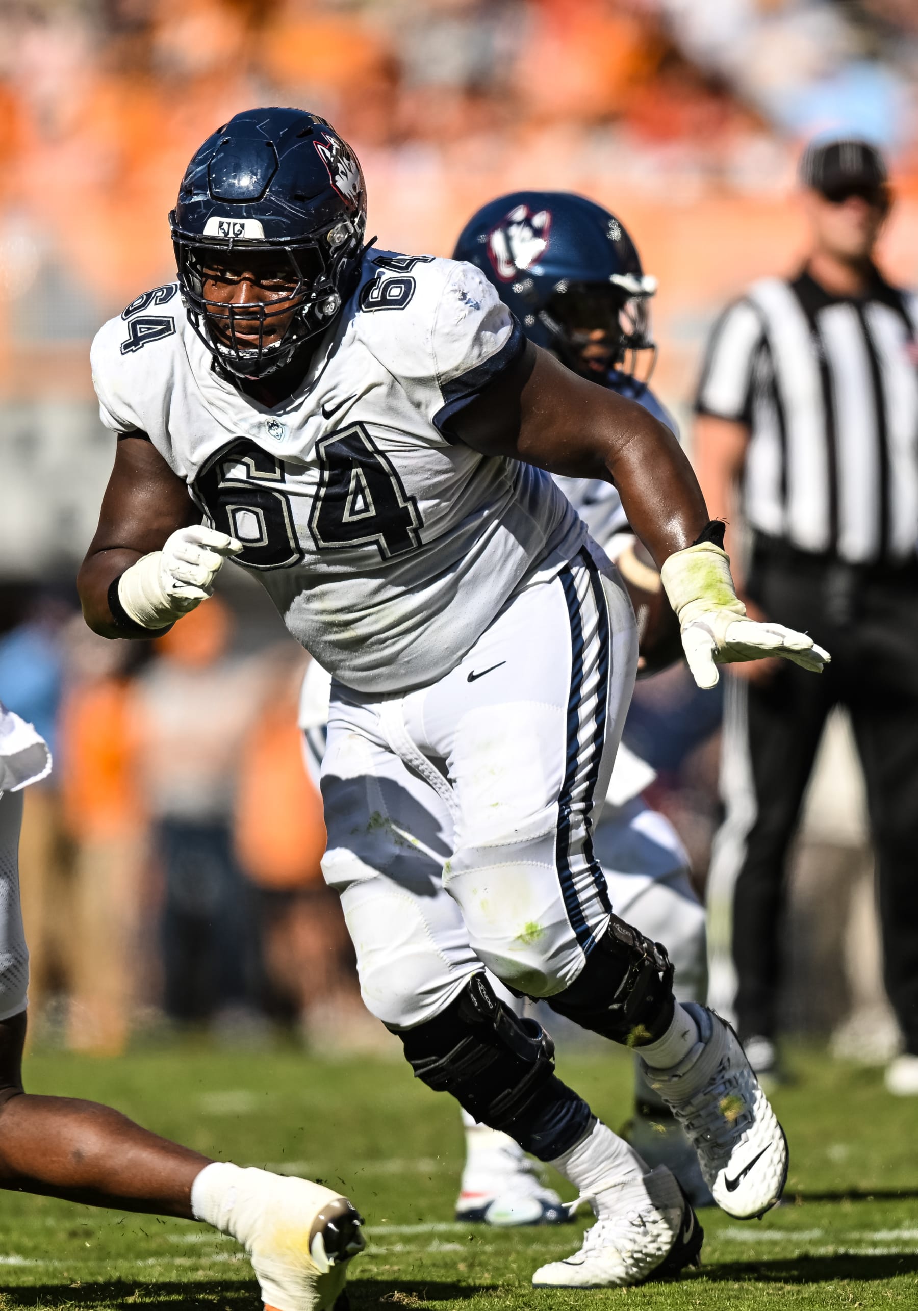 KNOXVILLE, TN - NOVEMBER 04: Connecticut Huskies offensive lineman Christian Haynes (64) blocks during the college football game between the Tennessee Volunteers and the Connecticut Huskies on November 4, 2023, at Neyland Stadium, in Knoxville, TN. (Photo by Bryan Lynn/Icon Sportswire via Getty Images)