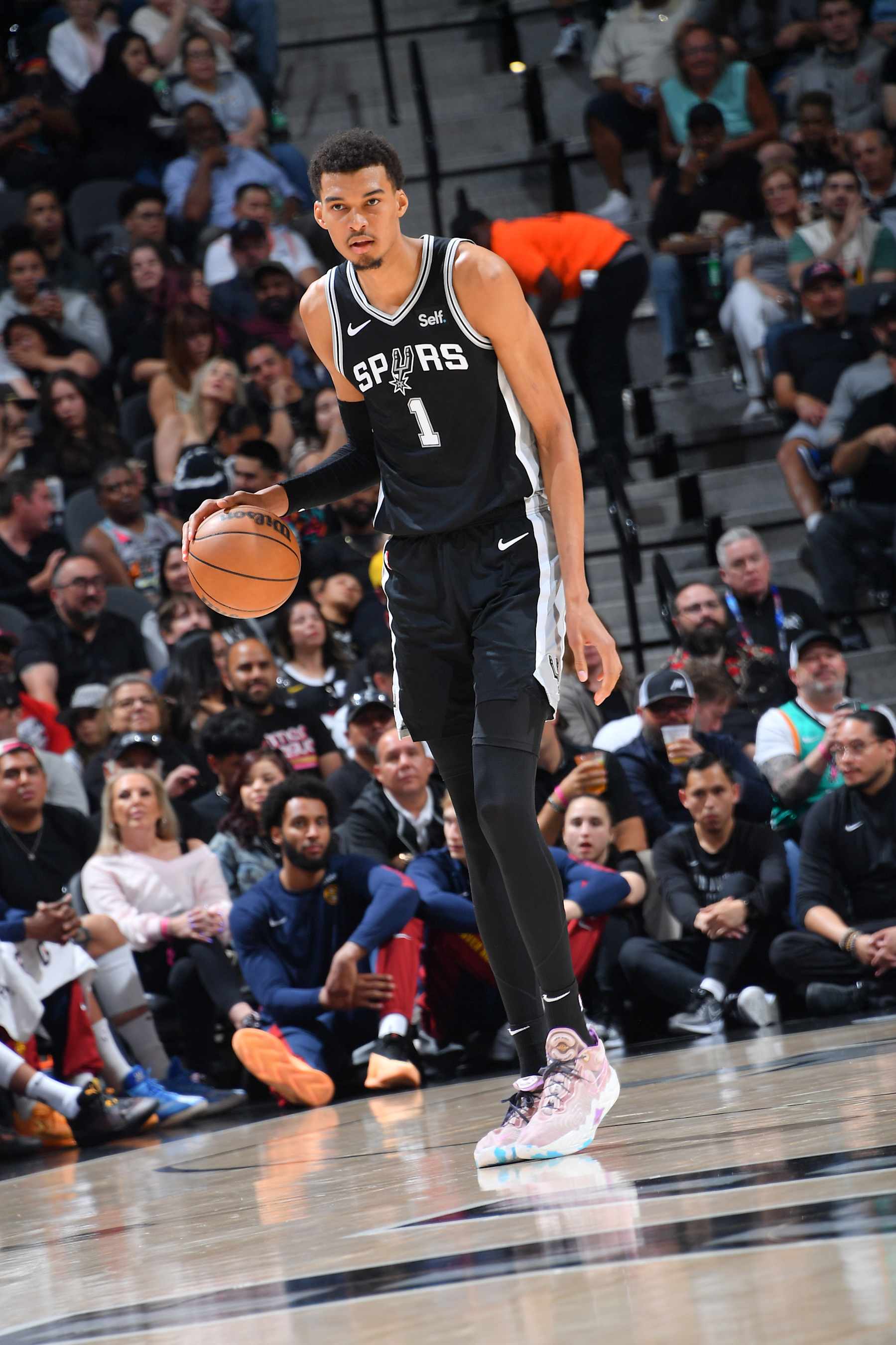 SAN ANTONIO, TX - APRIL 12: Victor Wembanyama #1 of the San Antonio Spurs handles the ball during the game  on April 12, 2024 at the Frost Bank Center in San Antonio, Texas. NOTE TO USER: User expressly acknowledges and agrees that, by downloading and or using this photograph, user is consenting to the terms and conditions of the Getty Images License Agreement. Mandatory Copyright Notice: Copyright 2024 NBAE (Photos by Michael Gonzales/NBAE via Getty Images)