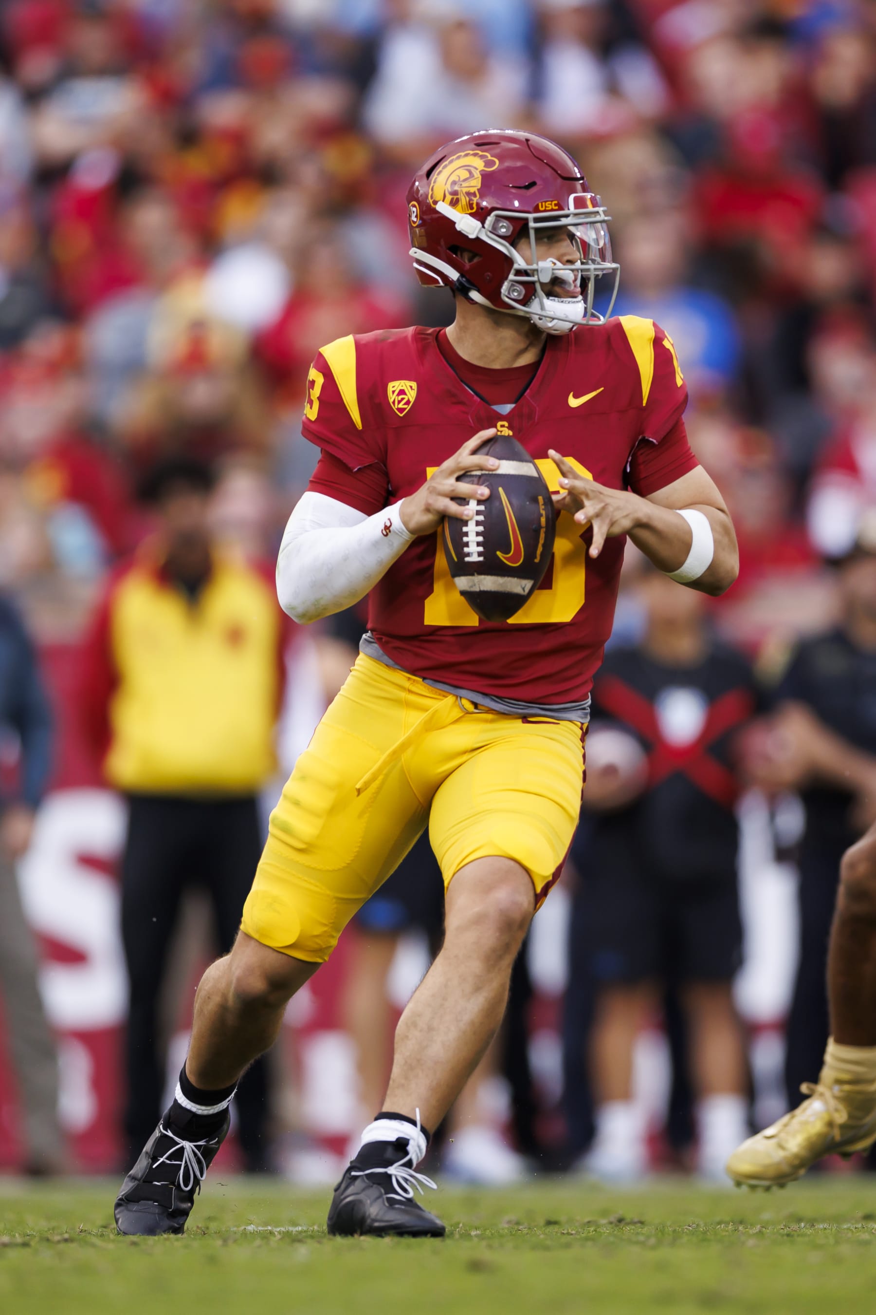 LOS ANGELES, CALIFORNIA - NOVEMBER 18: Caleb Williams #13 of the USC Trojans rolls out and looks to throw a pass during the first half of a game against the UCLA Bruins at United Airlines Field at the Los Angeles Memorial Coliseum on November 18, 2023 in Los Angeles, California. (Photo by Ryan Kang/Getty Images)