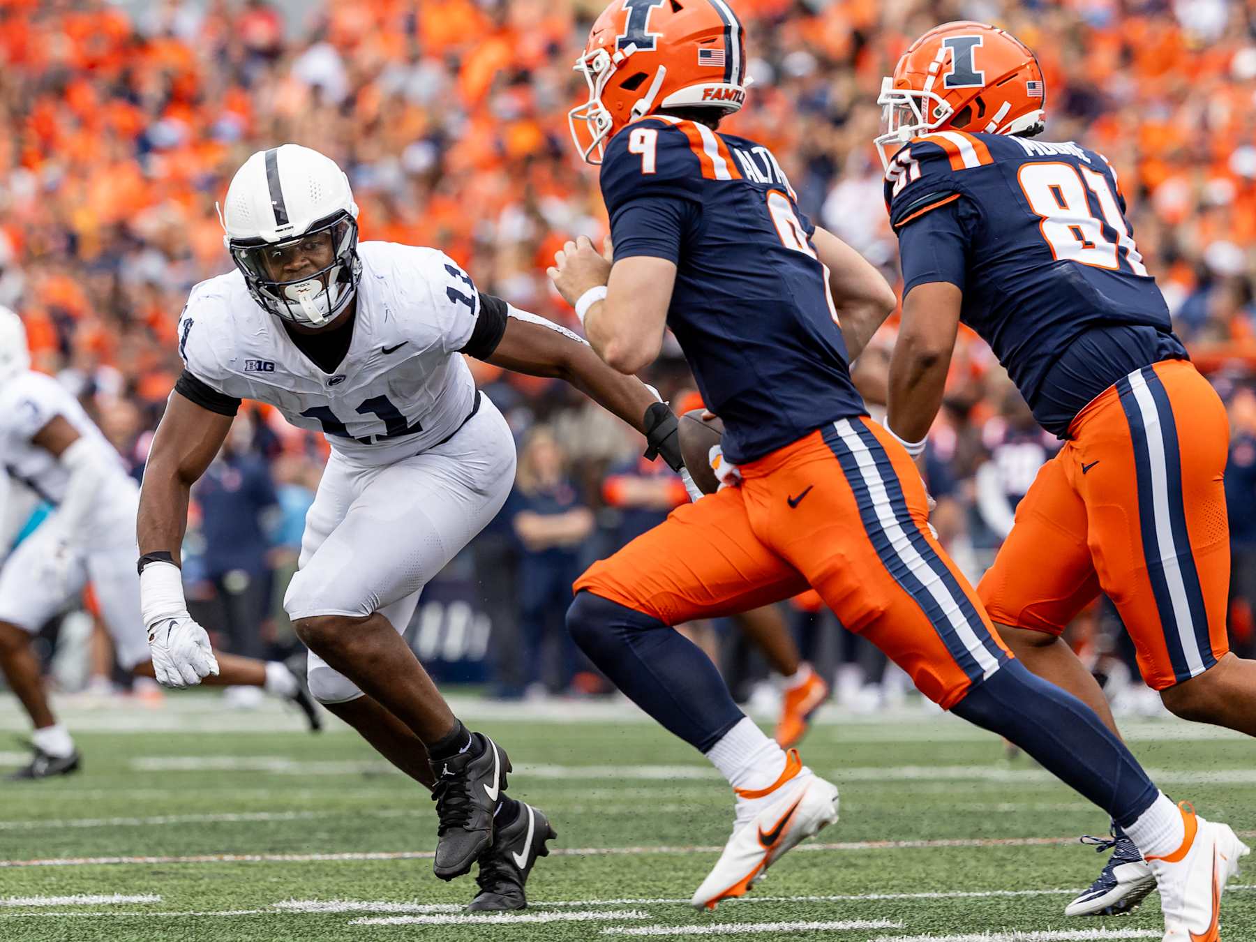 CHAMPAIGN, ILLINOIS - SEPTEMBER 16: Abdul Carter #11 of the Penn State Nittany Lions looks to make the tackle on Luke Altmyer #9 of the Illinois Fighting Illini at Memorial Stadium on September 16, 2023 in Champaign, Illinois. (Photo by Michael Hickey/Getty Images)