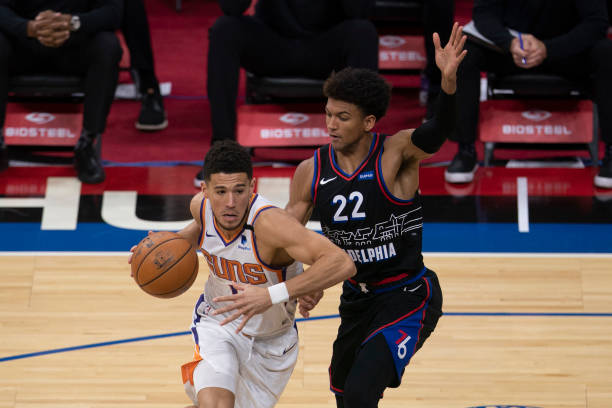 PHILADELPHIA, PA - APRIL 21: Devin Booker #1 of the Phoenix Suns dribbles the ball against Matisse Thybulle #22 of the Philadelphia 76ers in the third quarter at the Wells Fargo Center on April 21, 2021 in Philadelphia, Pennsylvania. NOTE TO USER: User expressly acknowledges and agrees that, by downloading and or using this photograph, User is consenting to the terms and conditions of the Getty Images License Agreement. (Photo by Mitchell Leff/Getty Images)