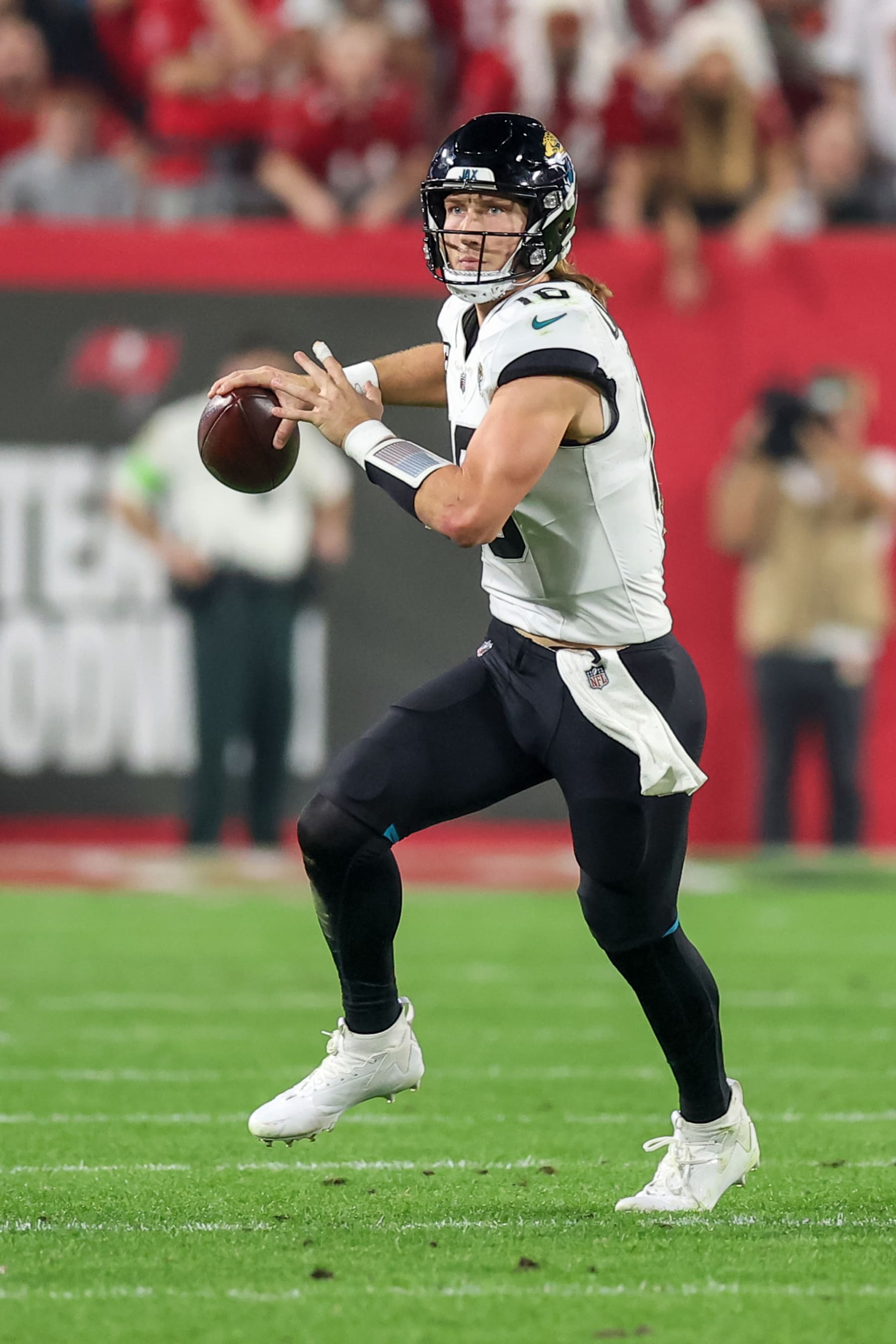 TAMPA, FLORIDA - DECEMBER 24: Trevor Lawrence #16 of the Jacksonville Jaguars scrambles during the second half of the game against the Tampa Bay Buccaneers at Raymond James Stadium on December 24, 2023 in Tampa, Florida. (Photo by Mike Carlson/Getty Images)