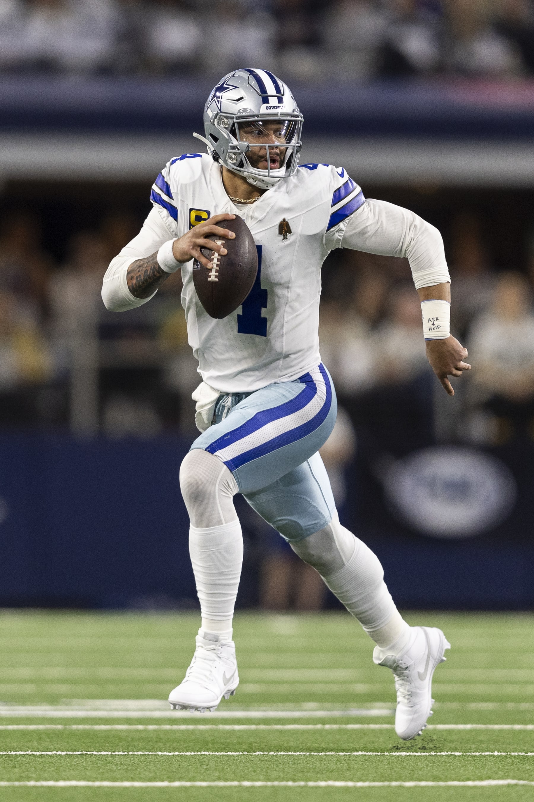 ARLINGTON, TEXAS - JANUARY 14: Dak Prescott #4 of the Dallas Cowboys scrambles and runs with the ball during an NFL wild-card playoff football game between the Dallas Cowboys and the Green Bay Packers at AT&T Stadium on January 14, 2024 in Arlington, Texas. (Photo by Michael Owens/Getty Images)