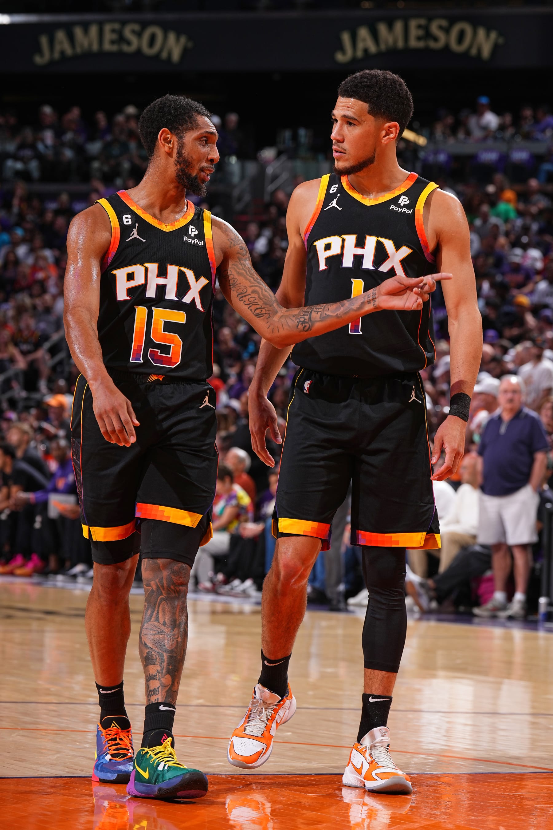 PHOENIX, AZ - MAY 5: Cameron Payne #15 and Devin Booker #1 of the Phoenix Suns talk during Game Three of the Western Conference Semi-Finals of the 2023 NBA Playoffs against the Denver Nuggets on May 5, 2023 at Footprint Center in Phoenix, Arizona. NOTE TO USER: User expressly acknowledges and agrees that, by downloading and or using this photograph, user is consenting to the terms and conditions of the Getty Images License Agreement. Mandatory Copyright Notice: Copyright 2023 NBAE (Photo by Garrett Ellwood/NBAE via Getty Images)