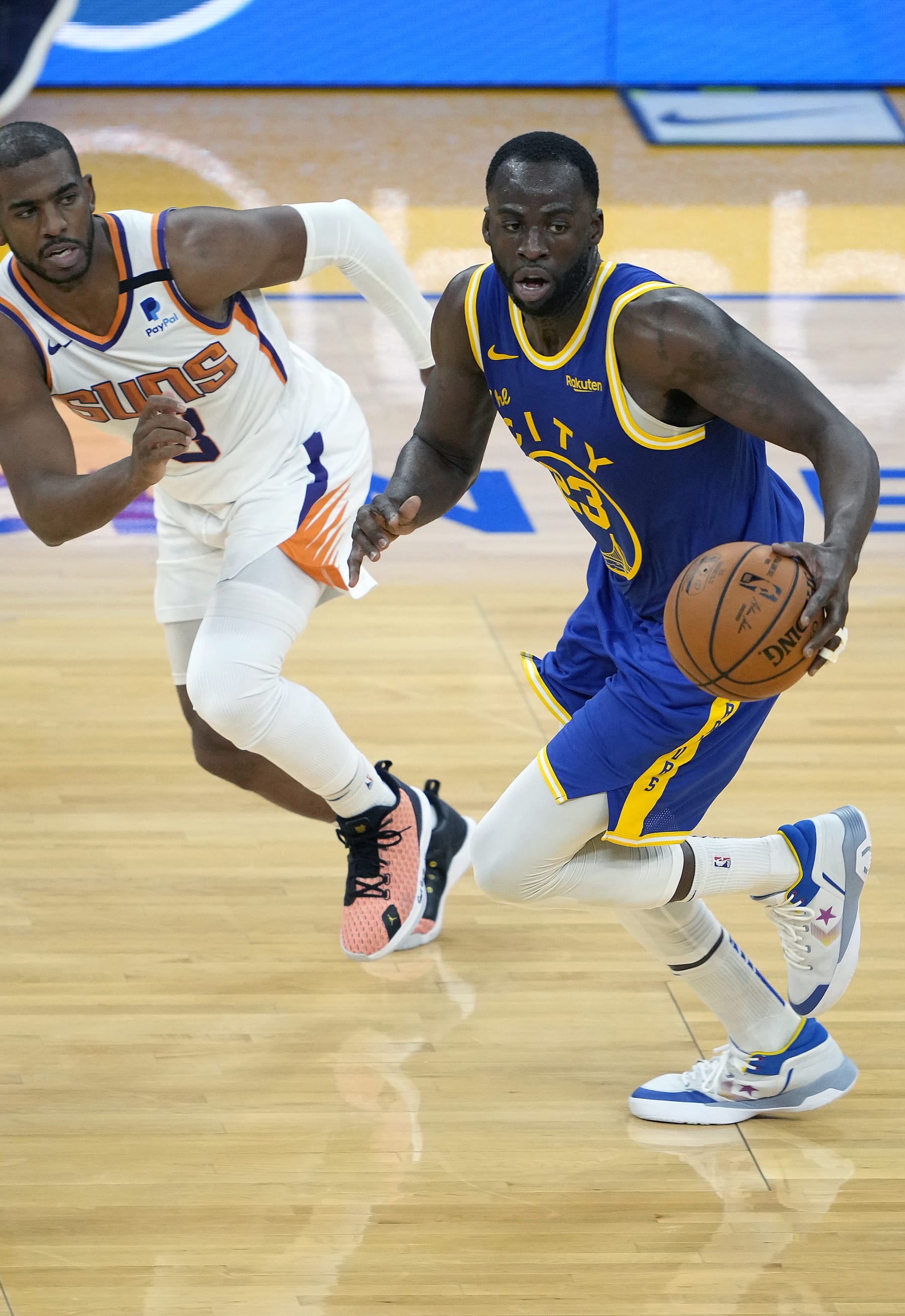 SAN FRANCISCO, CALIFORNIA - MAY 11: Draymond Green #23 of the Golden State Warriors dribbles the ball up court pursued by Chris Paul #3 of the Phoenix Suns during the second half of an NBA basketball game at Chase Center on May 11, 2021 in San Francisco, California. NOTE TO USER: User expressly acknowledges and agrees that, by downloading and or using this photograph, User is consenting to the terms and conditions of the Getty Images License Agreement. (Photo by Thearon W. Henderson/Getty Images)