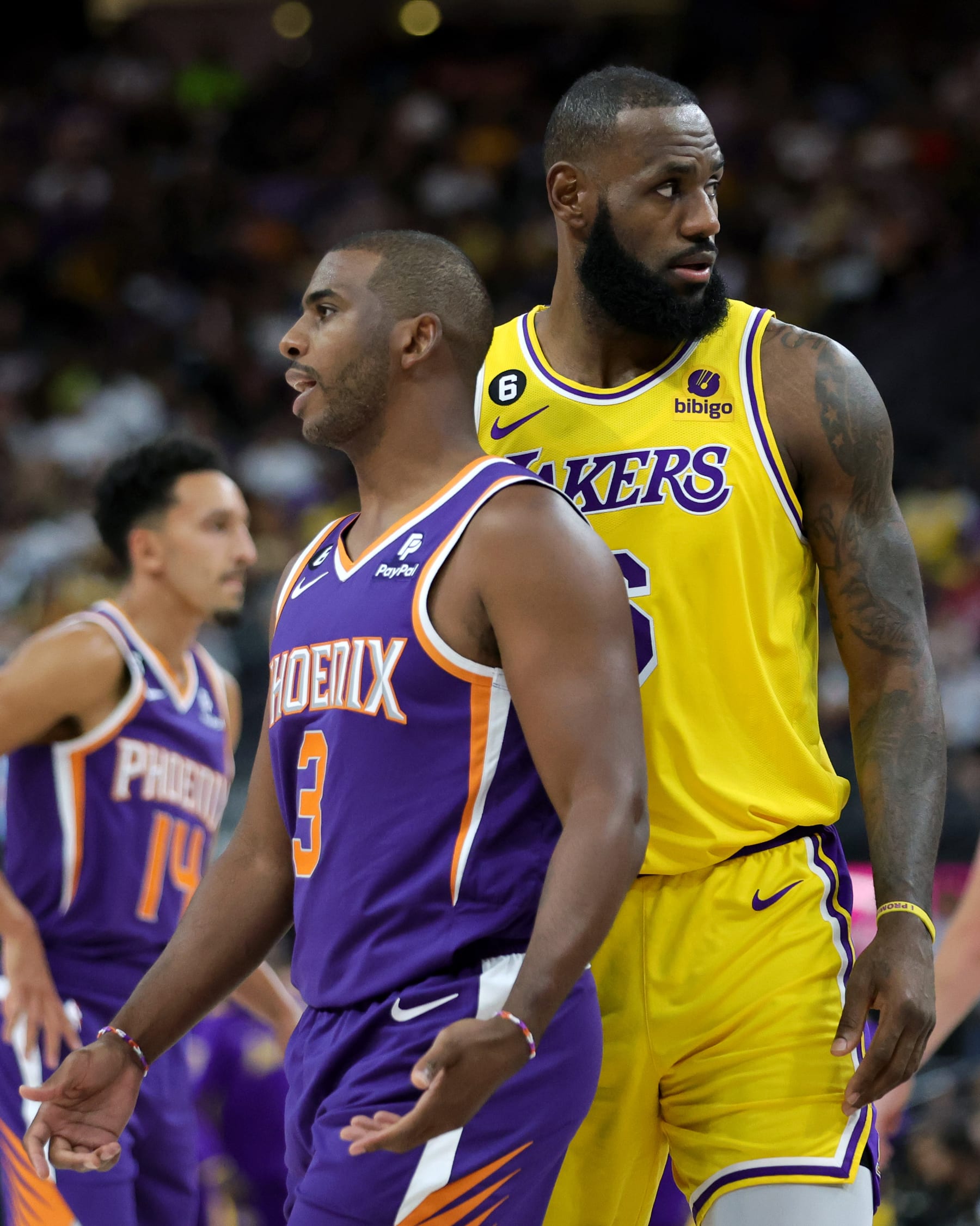 LAS VEGAS, NEVADA - OCTOBER 05: Chris Paul #3 of the Phoenix Suns and LeBron James #6 of the Los Angeles Lakers stand on the court during a break in the second quarter of their preseason game at T-Mobile Arena on October 05, 2022 in Las Vegas, Nevada. The Suns defeated the Lakers 119-115. NOTE TO USER: User expressly acknowledges and agrees that, by downloading and or using this photograph, User is consenting to the terms and conditions of the Getty Images License Agreement. (Photo by Ethan Miller/Getty Images)