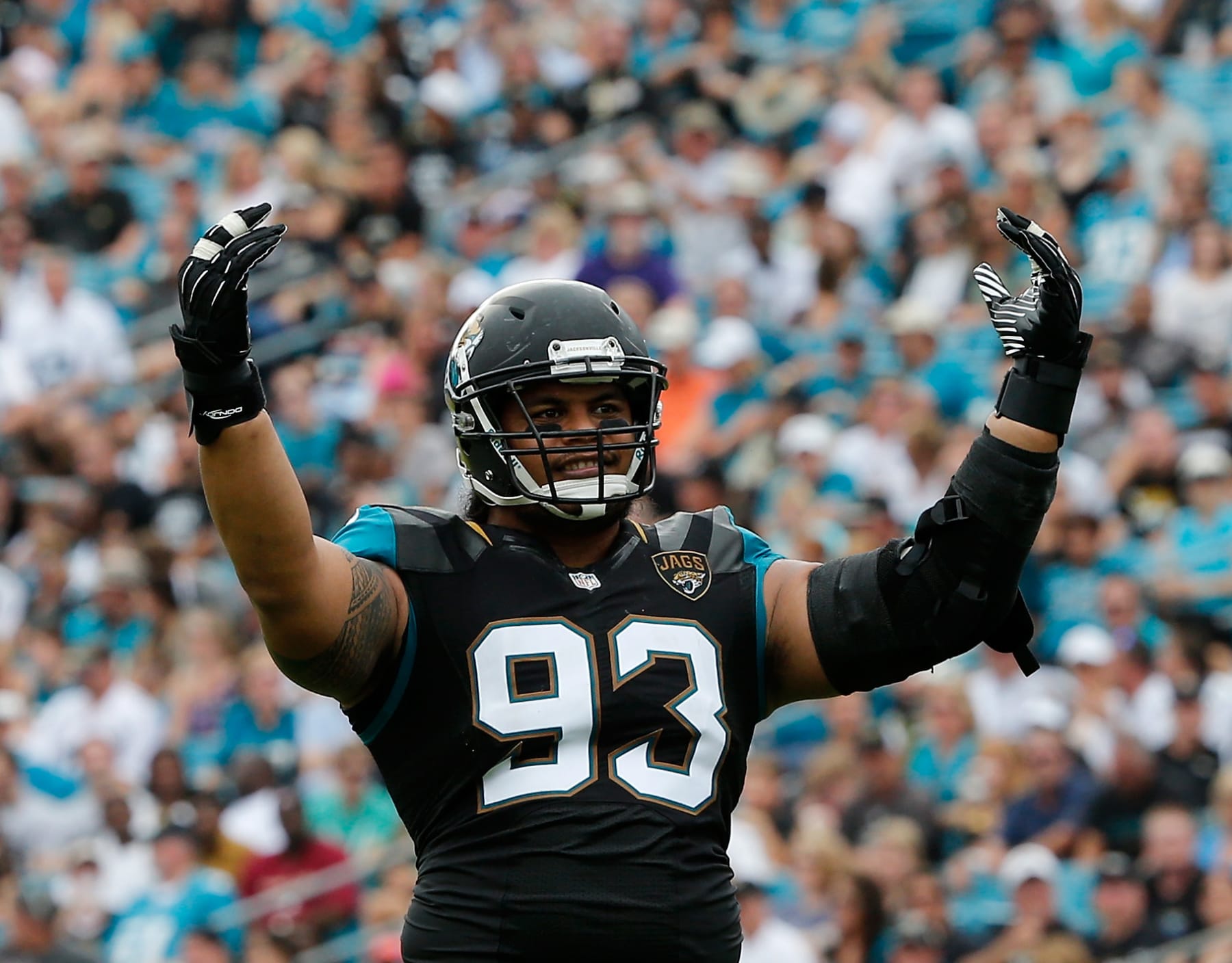 JACKSONVILLE, FL - NOVEMBER 17:   Tyson Alualu #93 of the Jacksonville Jaguars asks the crowd for noise during the game against the Arizona Cardinals at EverBank Field on November 17, 2013 in Jacksonville, Florida.  (Photo by Sam Greenwood/Getty Images)