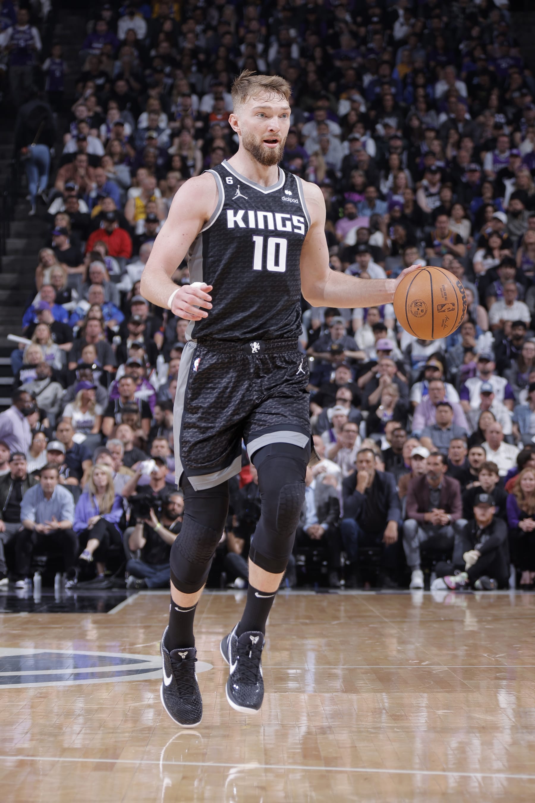 SACRAMENTO, CA - APRIL 17:  Domantas Sabonis #10 of the Sacramento Kings dribbles the ball against the Golden State Warriors during Round 1 Game 2 of the 2023 NBA Playoffs on April 17, 2023 at Golden 1 Center in Sacramento, California. NOTE TO USER: User expressly acknowledges and agrees that, by downloading and or using this Photograph, user is consenting to the terms and conditions of the Getty Images License Agreement. Mandatory Copyright Notice: Copyright 2023 NBAE (Photo by Rocky Widner/NBAE via Getty Images)
