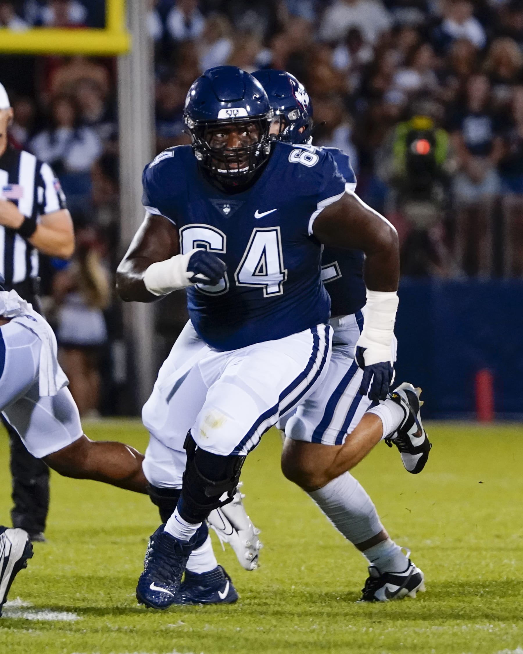 EAST HARTFORD, CT - AUGUST 31: Connecticut Huskies Offensive Lineman Christian Haynes (64) looks to block during the first half of the College Football game between the North Carolina State Wolfpack and the Connecticut Huskies on August 31, 2023,, at Pratt and Whitney Stadium in East Hartford, CT. (Photo by Gregory Fisher/Icon Sportswire via Getty Images)