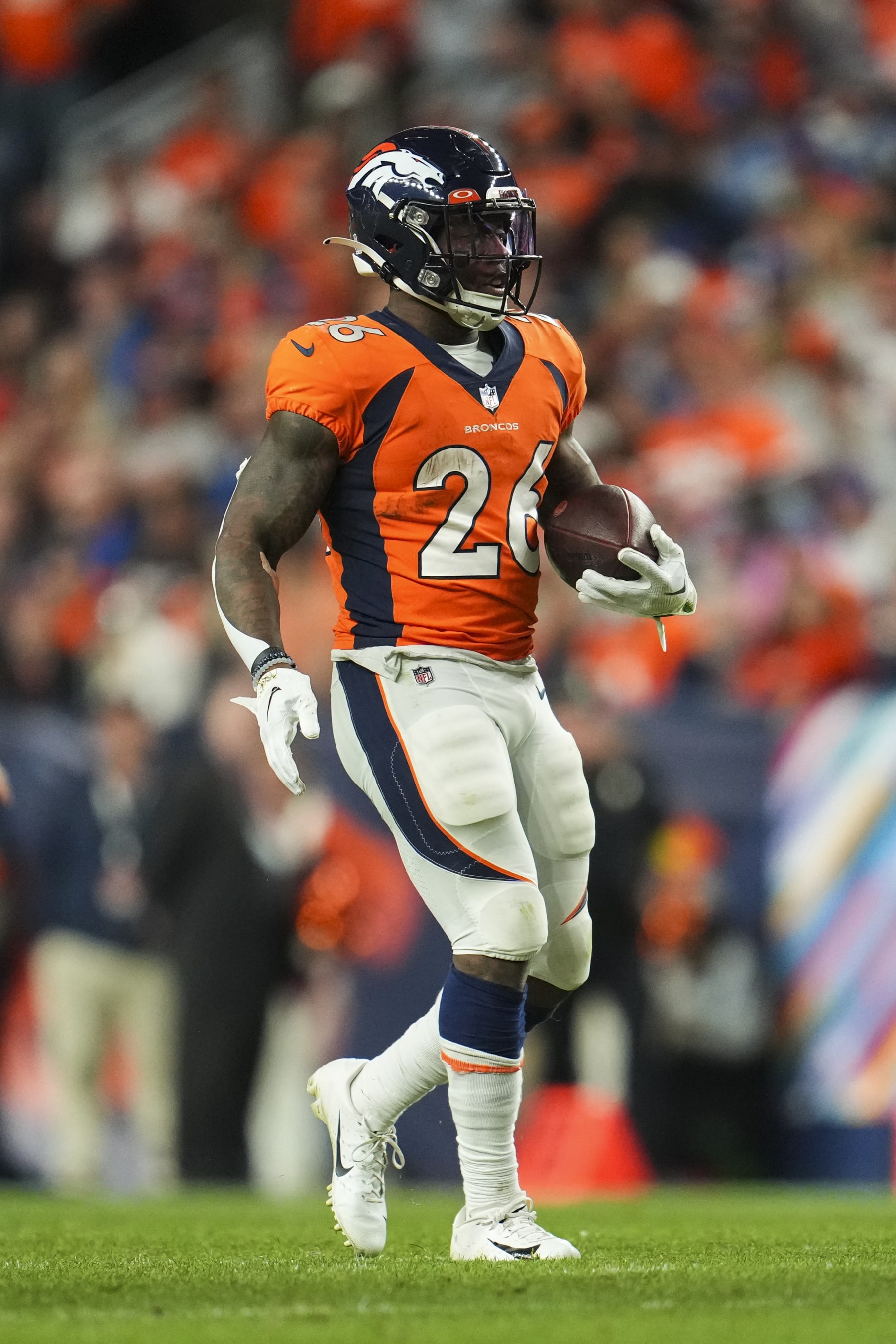DENVER, CO - OCTOBER 06: Mike Boone #26 of the Denver Broncos runs the ball against the Indianapolis Colts at Empower Field at Mile High on October 6, 2022 in Denver, Texas. (Photo by Cooper Neill/Getty Images)