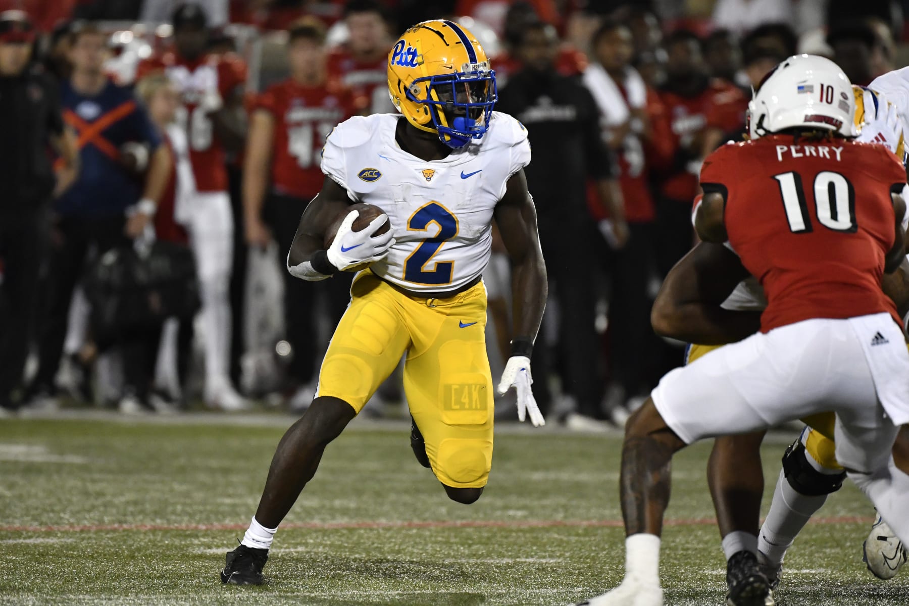Pittsburgh running back Israel Abanikanda (2) looks for an opening in the Louisville line during the first half of an NCAA college football game in Louisville, Ky., Saturday, Oct. 22, 2022. (AP Photo/Timothy D. Easley)