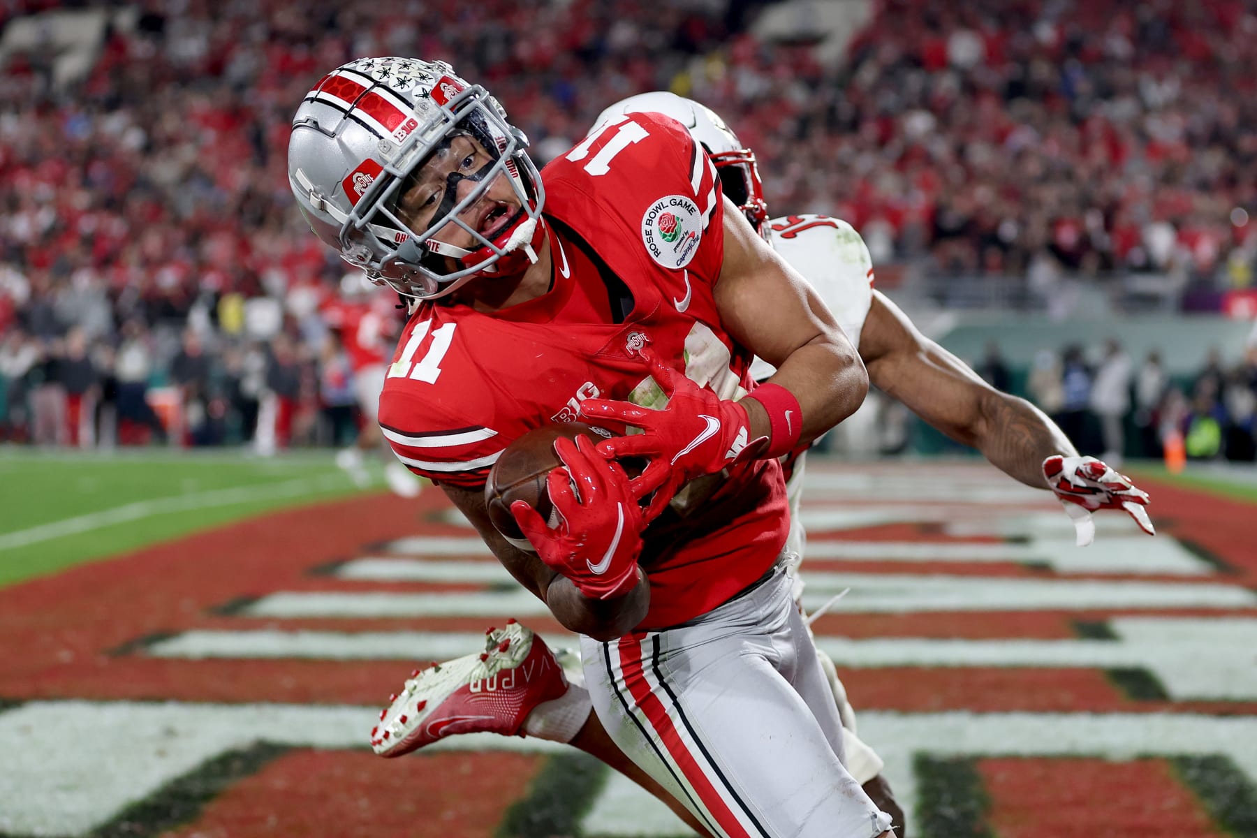 PASADENA, CALIFORNIA - JANUARY 01: Jaxon Smith-Njigba #11 of the Ohio State Buckeyes catches a touchdown pass against the Utah Utes during the fourth quarter in the Rose Bowl Game at Rose Bowl Stadium on January 01, 2022 in Pasadena, California. (Photo by Sean M. Haffey/Getty Images)