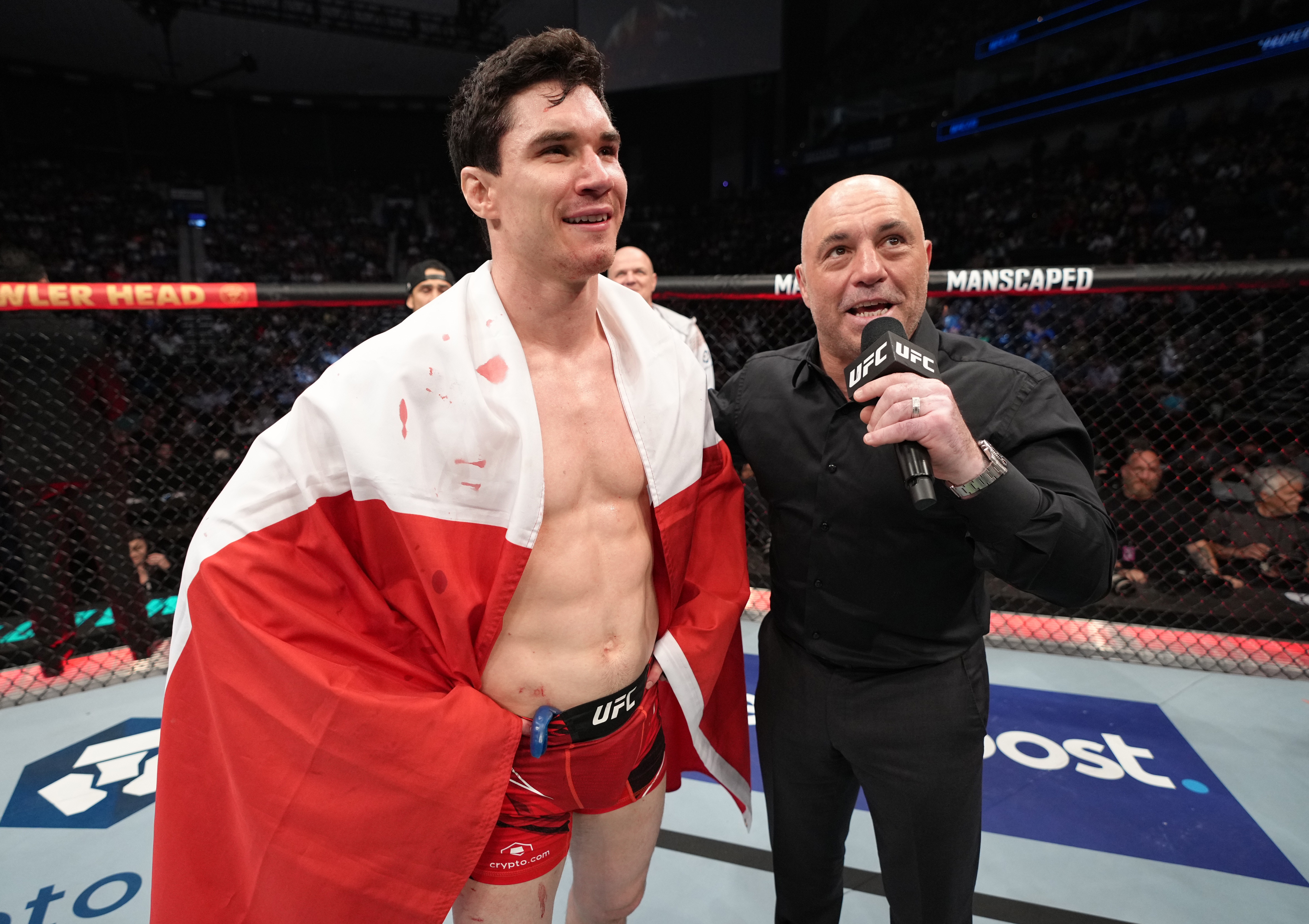 JACKSONVILLE, FLORIDA - APRIL 09: Mike Malott of Canada is interviewed by Joe Rogan after his victory over Mickey Gall in their welterweight fight during the UFC 273 event at VyStar Veterans Memorial Arena on April 09, 2022 in Jacksonville, Florida. (Photo by Jeff Bottari/Zuffa LLC)
