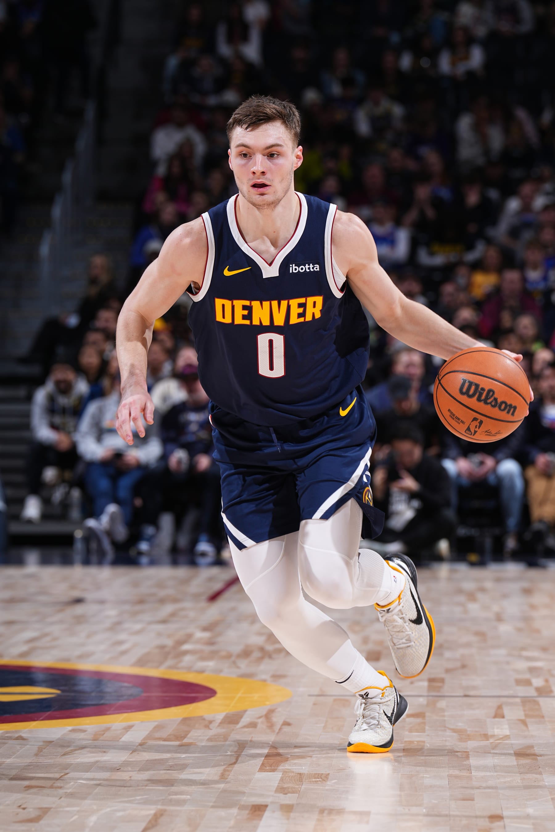 DENVER, CO - DECEMBER 14: Christian Braun #0 of the Denver Nuggets dribbles the ball during the game against the Brooklyn Nets on December 14, 2023 at the Ball Arena in Denver, Colorado. NOTE TO USER: User expressly acknowledges and agrees that, by downloading and/or using this Photograph, user is consenting to the terms and conditions of the Getty Images License Agreement. Mandatory Copyright Notice: Copyright 2023 NBAE (Photo by Garrett Ellwood/NBAE via Getty Images)