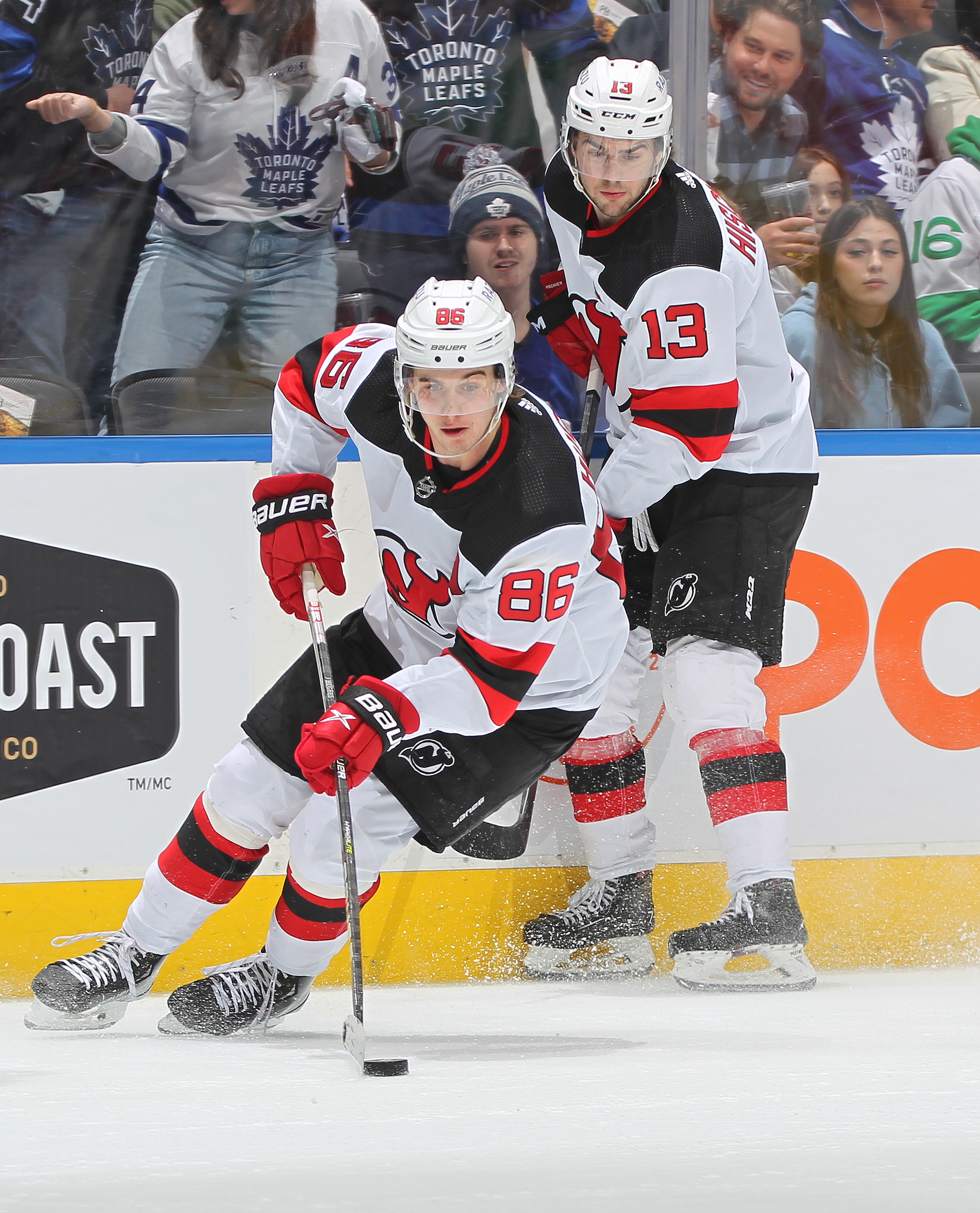 TORONTO, ON - MARCH 23:  Jack Hughes #86 and Nico Hischier #13 of the New Jersey Devils skate against the Toronto Maple Leafs during an NHL game at Scotiabank Arena on March 23, 2022 in Toronto, Ontario, Canada. The Maple Leafs defeated the Devils 3-2. (Photo by Claus Andersen/Getty Images)