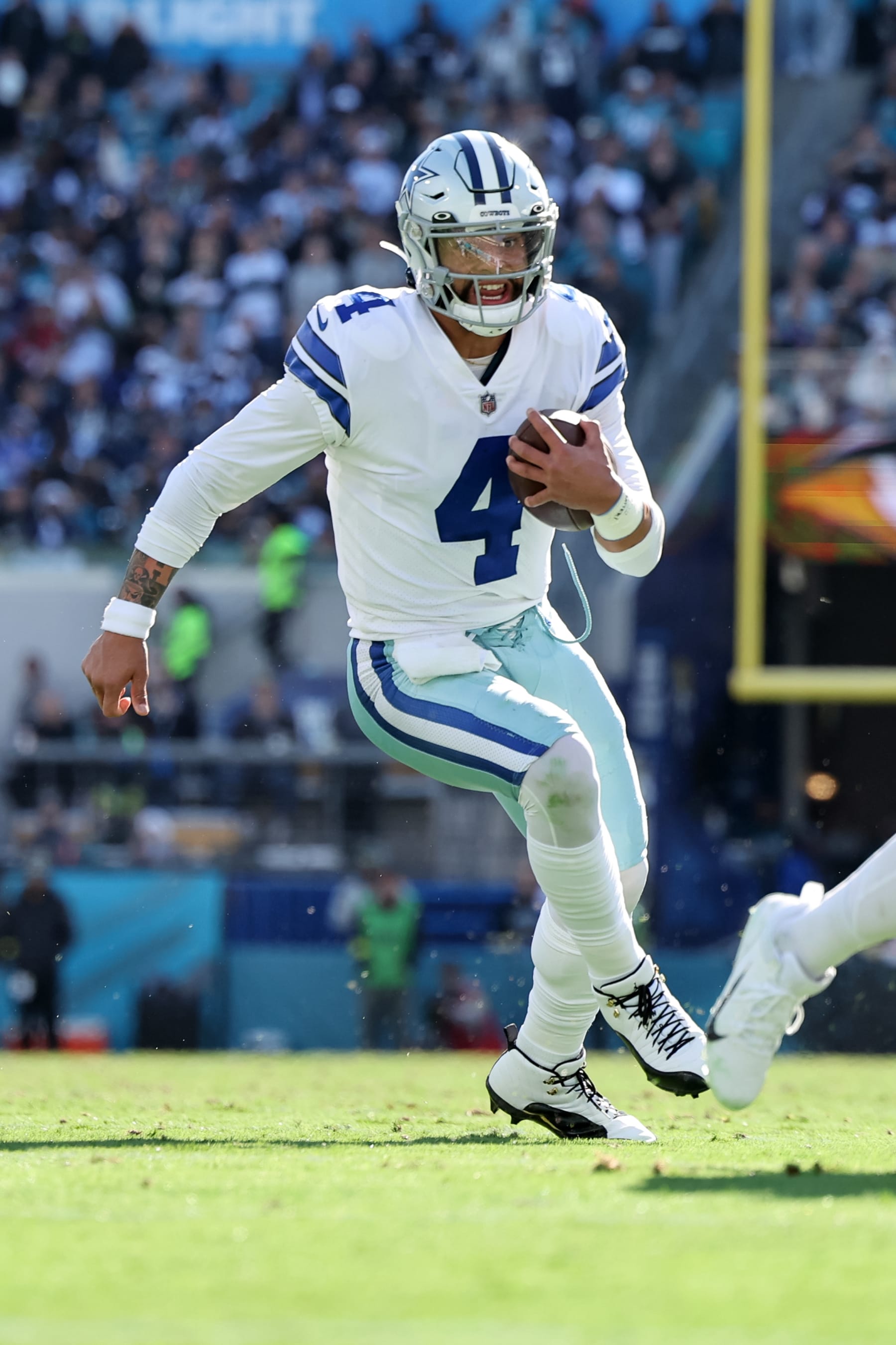 JACKSONVILLE, FLORIDA - DECEMBER 18: Dak Prescott #4 of the Dallas Cowboys runs against the Jacksonville Jaguars during the game at TIAA BANK Stadium on December 18, 2022 in Jacksonville, Florida. (Photo by Mike Carlson/Getty Images)