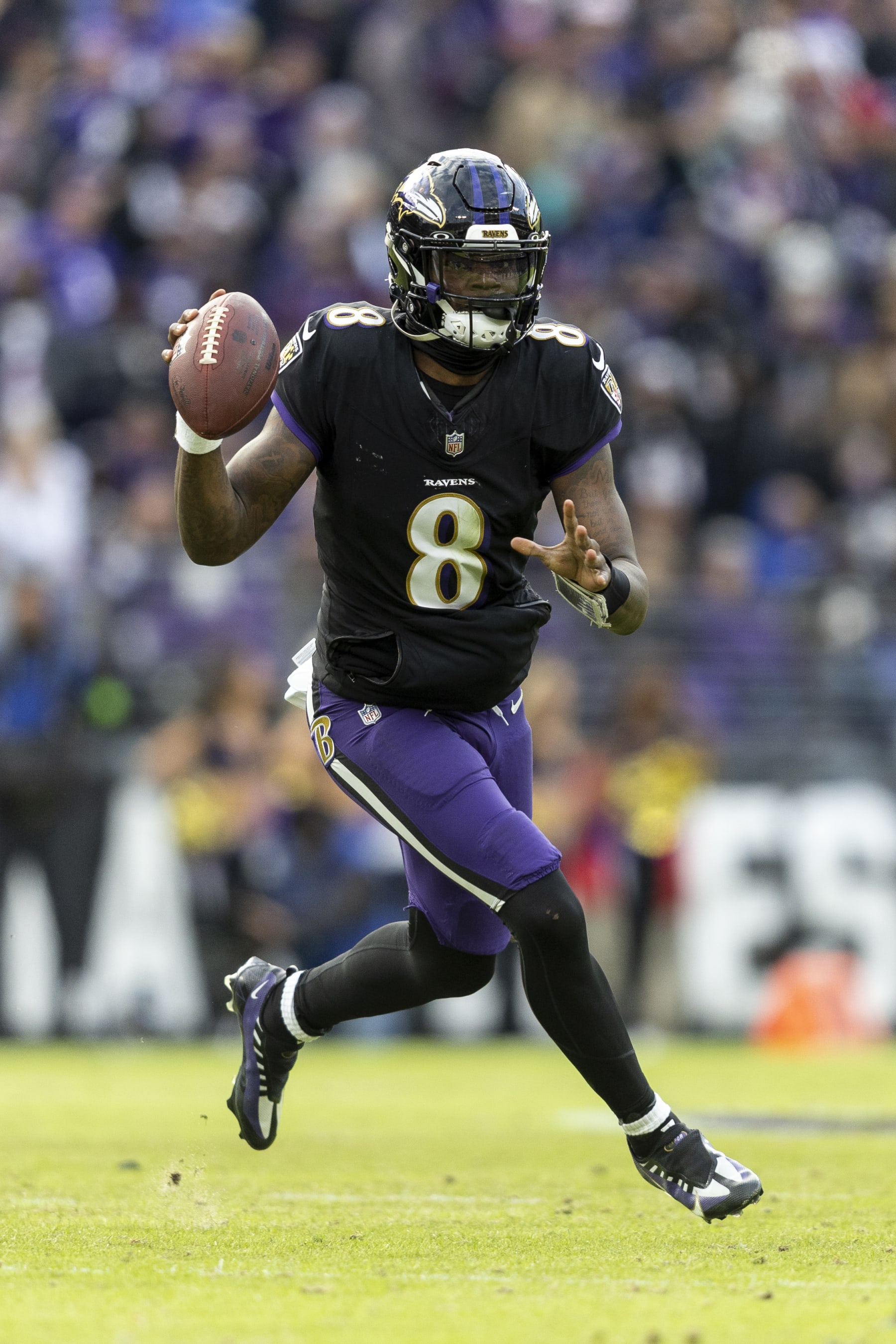 BALTIMORE, MARYLAND - DECEMBER 31: Lamar Jackson #8 of the Baltimore Ravens runs with the ball and looks to pass during an NFL football game between the Baltimore Ravens and the Miami Dolphins at M&T Bank Stadium on December 31, 2023 in Baltimore, Maryland. (Photo by Michael Owens/Getty Images)