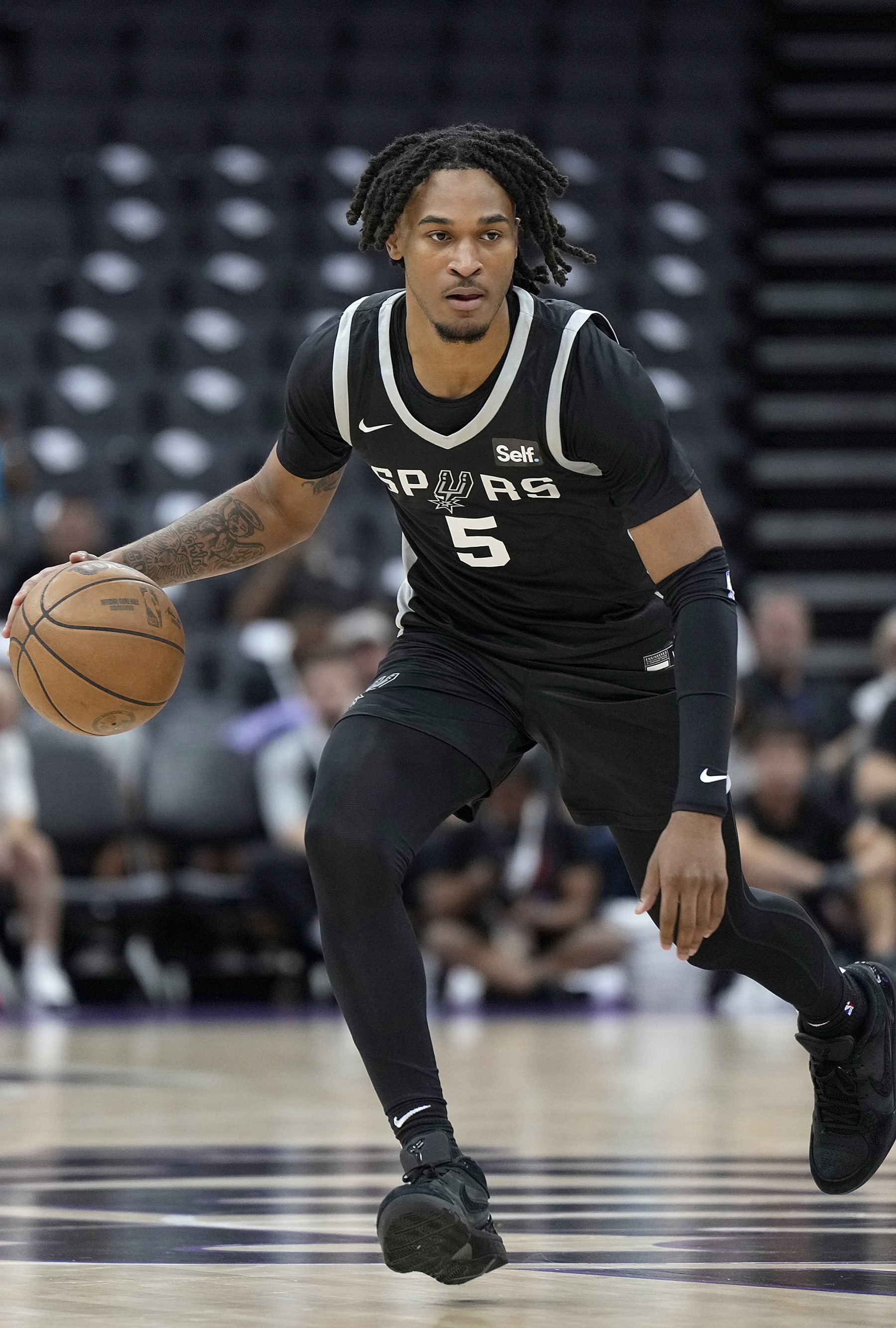SACRAMENTO, CALIFORNIA - JULY 09: Stephon Castle #5 of the San Antonio Spurs dribbles the ball up court against Team China during the first half of the 2024 California Classic summer league game at Golden 1 Center on July 09, 2024 in Sacramento, California. NOTE TO USER: User expressly acknowledges and agrees that, by downloading and or using this photograph, User is consenting to the terms and conditions of the Getty Images License Agreement. (Photo by Thearon W. Henderson/Getty Images)