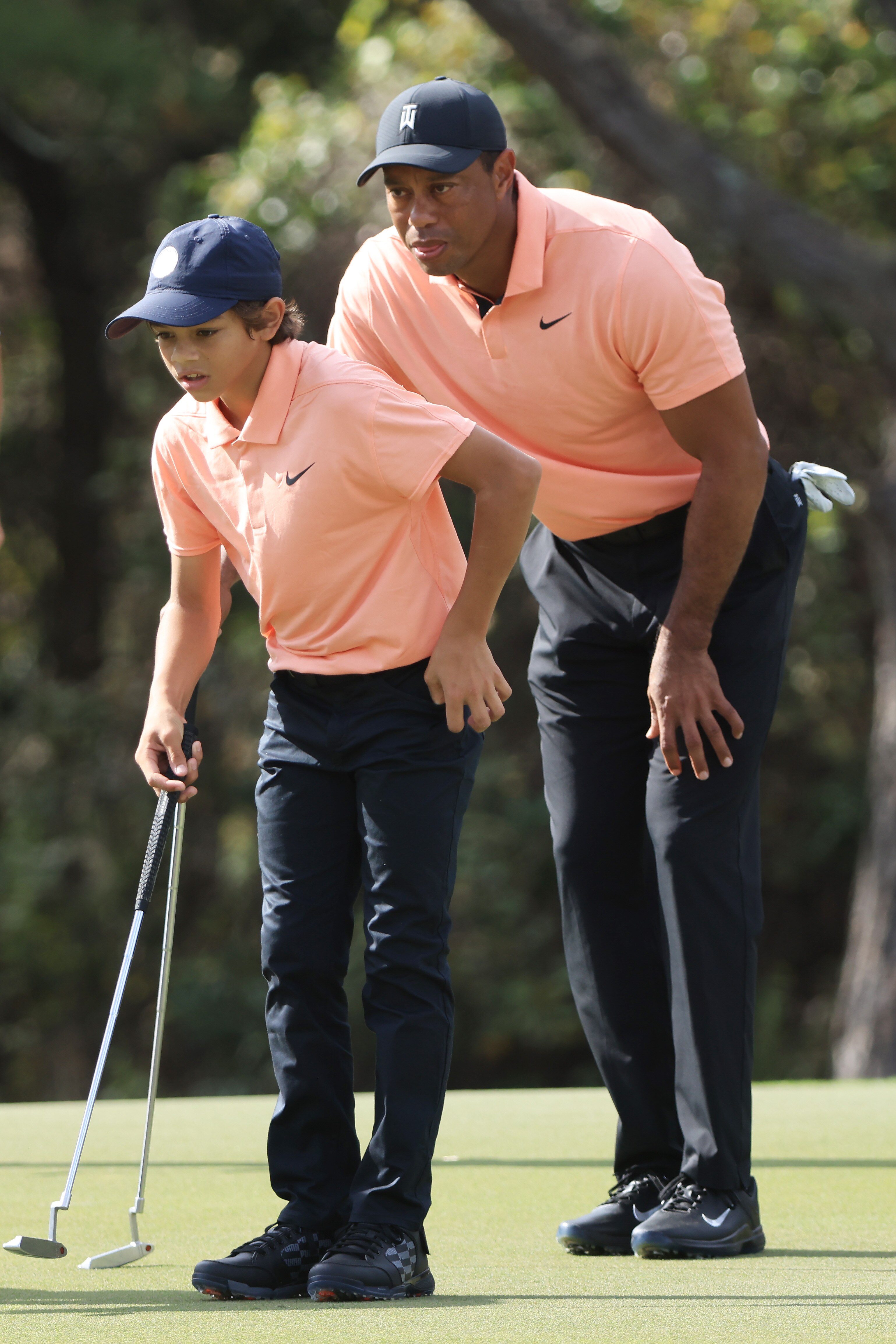 ORLANDO, FLORIDA - DECEMBER 18: Tiger Woods and Charlie Woods line up a putt during round one of the PNC Championship at the Ritz Carlton Golf Club Grande Lakes on December 18, 2021 in Orlando, Florida. (Photo by Sam Greenwood/Getty Images)