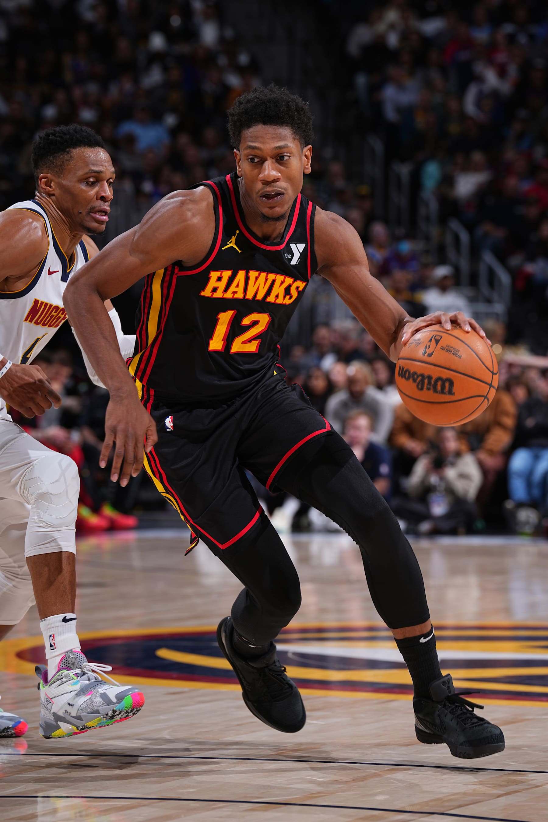 DENVER, CO - JANUARY 1: De'Andre Hunter #12 of the Atlanta Hawks dribbles the ball during the game against the Denver Nuggets on January 1, 2025 at Ball Arena in Denver, Colorado. NOTE TO USER: User expressly acknowledges and agrees that, by downloading and/or using this Photograph, user is consenting to the terms and conditions of the Getty Images License Agreement. Mandatory Copyright Notice: Copyright 2025 NBAE (Photo by Garrett Ellwood/NBAE via Getty Images)