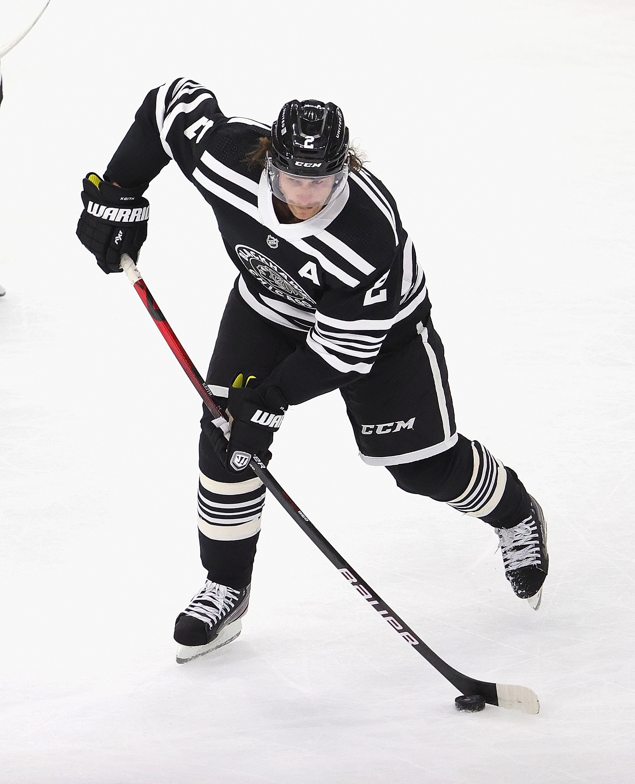 CHICAGO, ILLINOIS - APRIL 27: Duncan Keith #2 of the Chicago Blackhawks passes against the Tampa Bay Lightning at the United Center on April 27, 2021 in Chicago, Illinois. The Lightning defeated the Blackhawks 7-4. (Photo by Jonathan Daniel/Getty Images)