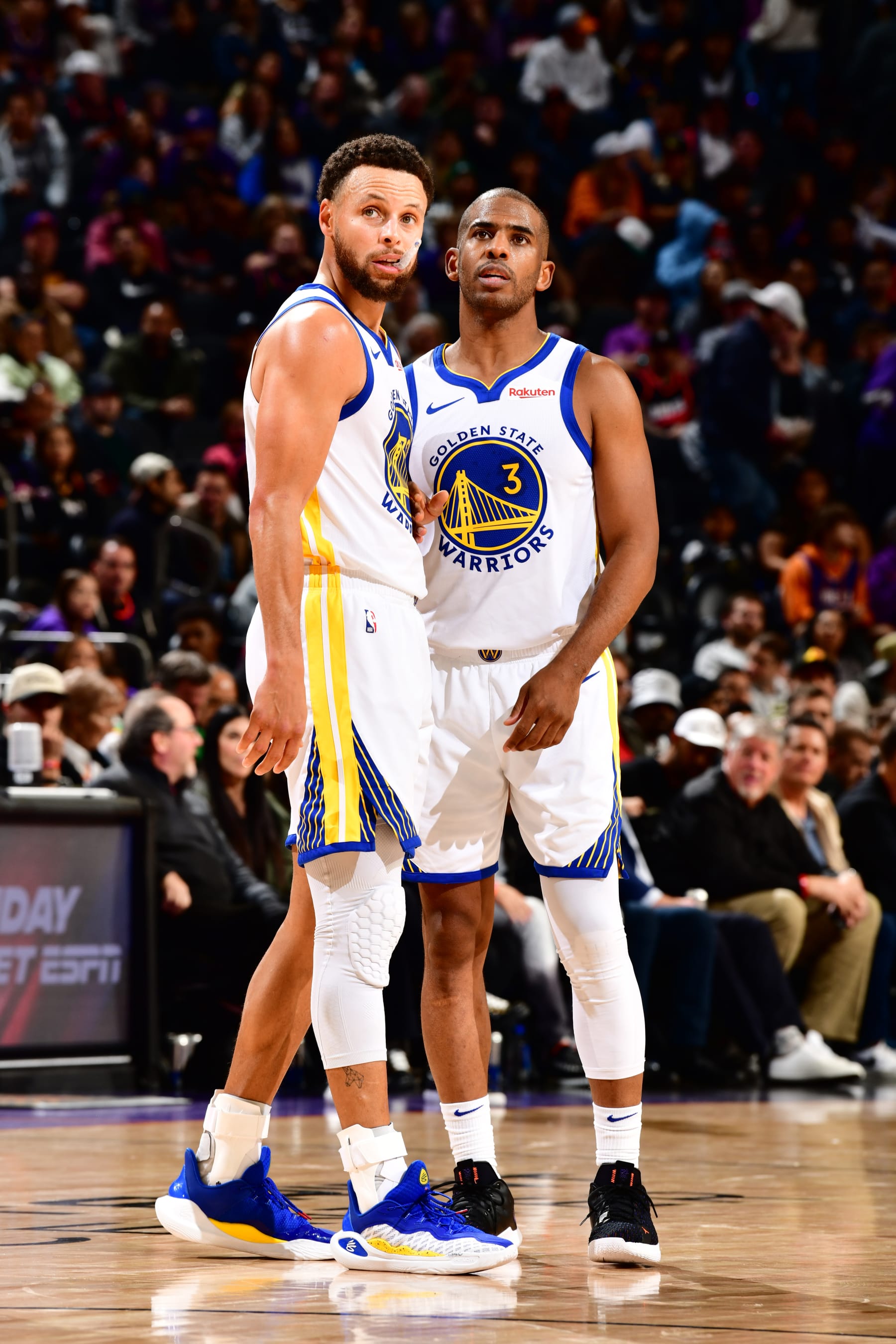 PHOENIX, AZ - DECEMBER 12: Stephen Curry #30 and Chris Paul #3 of the Golden State Warriors look on during the game against the Phoenix Suns on December 12, 2023 at Footprint Center in Phoenix, Arizona. NOTE TO USER: User expressly acknowledges and agrees that, by downloading and or using this photograph, user is consenting to the terms and conditions of the Getty Images License Agreement. Mandatory Copyright Notice: Copyright 2023 NBAE (Photo by Barry Gossage/NBAE via Getty Images)