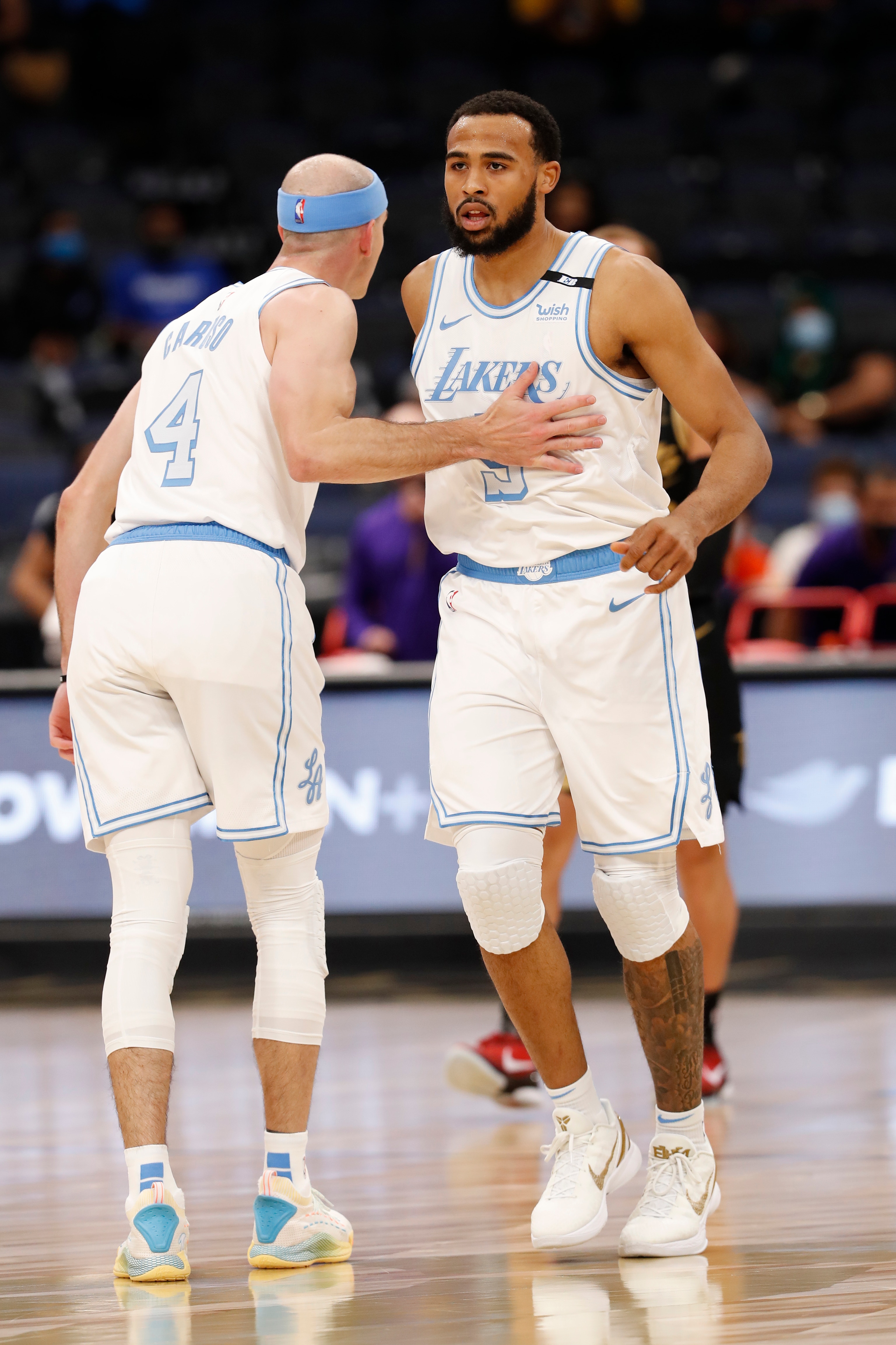 TAMPA, FL- APRIL 6: Talen Horton-Tucker #5 hi-fives Alex Caruso #4 of the Los Angeles Lakers during the game against the Toronto Raptors  on April 6, 2021 at Amalie Arena in Tampa, Florida. NOTE TO USER: User expressly acknowledges and agrees that, by downloading and or using this Photograph, user is consenting to the terms and conditions of the Getty Images License Agreement. Mandatory Copyright Notice: Copyright 2021 NBAE (Photo by Scott Audette/NBAE via Getty Images)