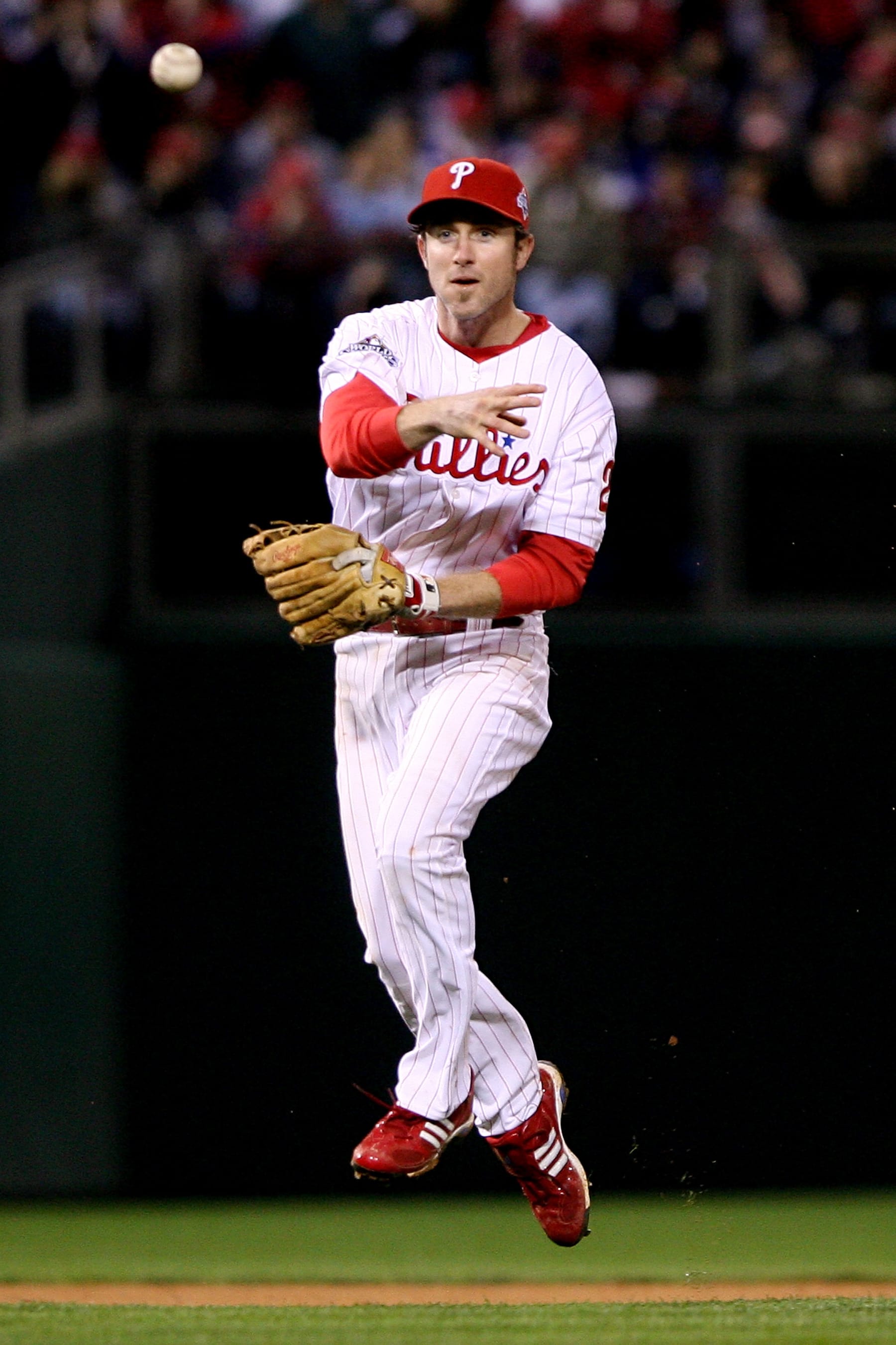 PHILADELPHIA - OCTOBER 25:  Chase Utley #26 of the Philadelphia Phillies throws to first against the Tampa Bay Rays during game three of the 2008 MLB World Series on October 25, 2008 at Citizens Bank Park in Philadelphia, Pennsylvania.  (Photo by Doug Pensinger/Getty Images)