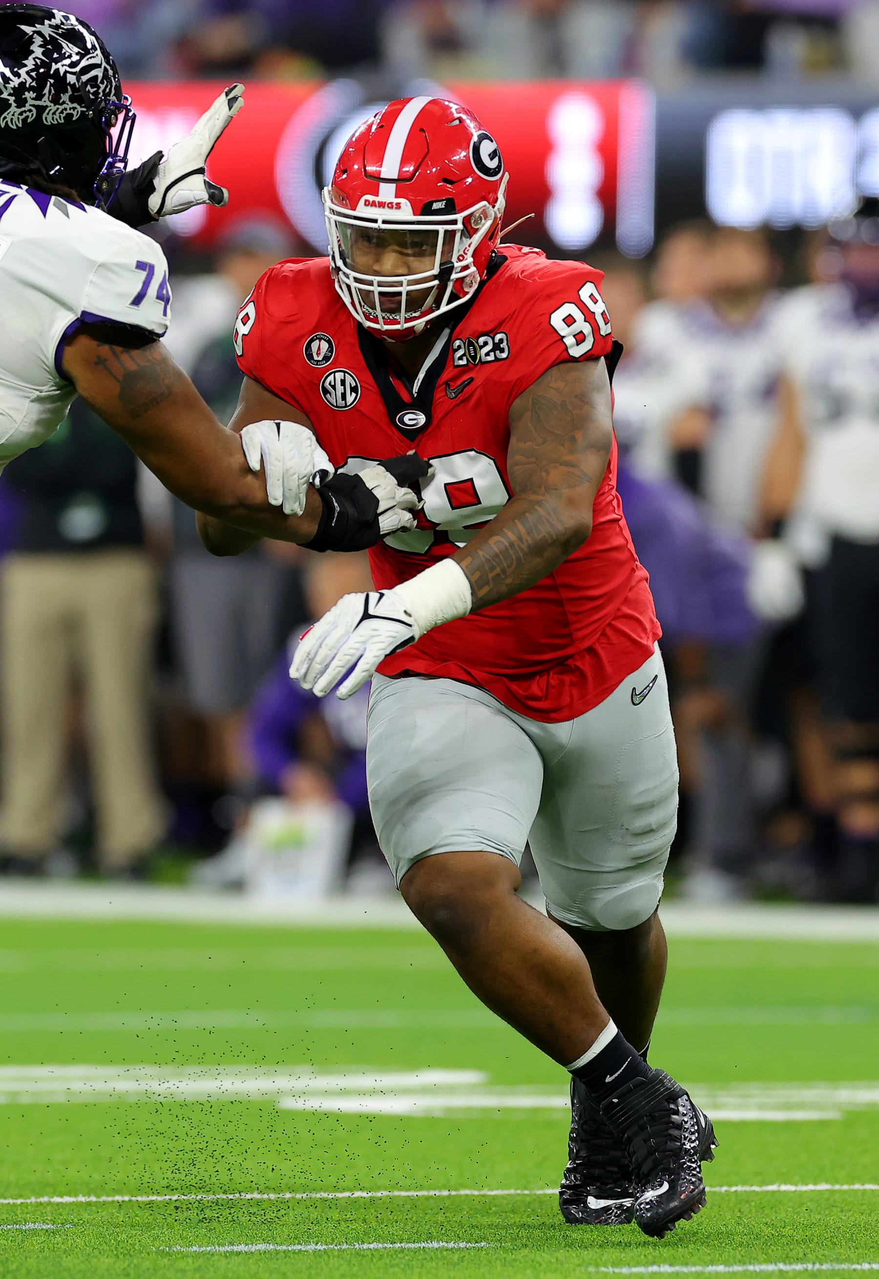 INGLEWOOD, CALIFORNIA - JANUARY 09: Jalen Carter #88 of the Georgia Bulldogs tries to get around Andrew Coker #74 of the TCU Horned Frogs during the second quarter in the College Football Playoff National Championship game at SoFi Stadium on January 09, 2023 in Inglewood, California. (Photo by Kevin C. Cox/Getty Images)