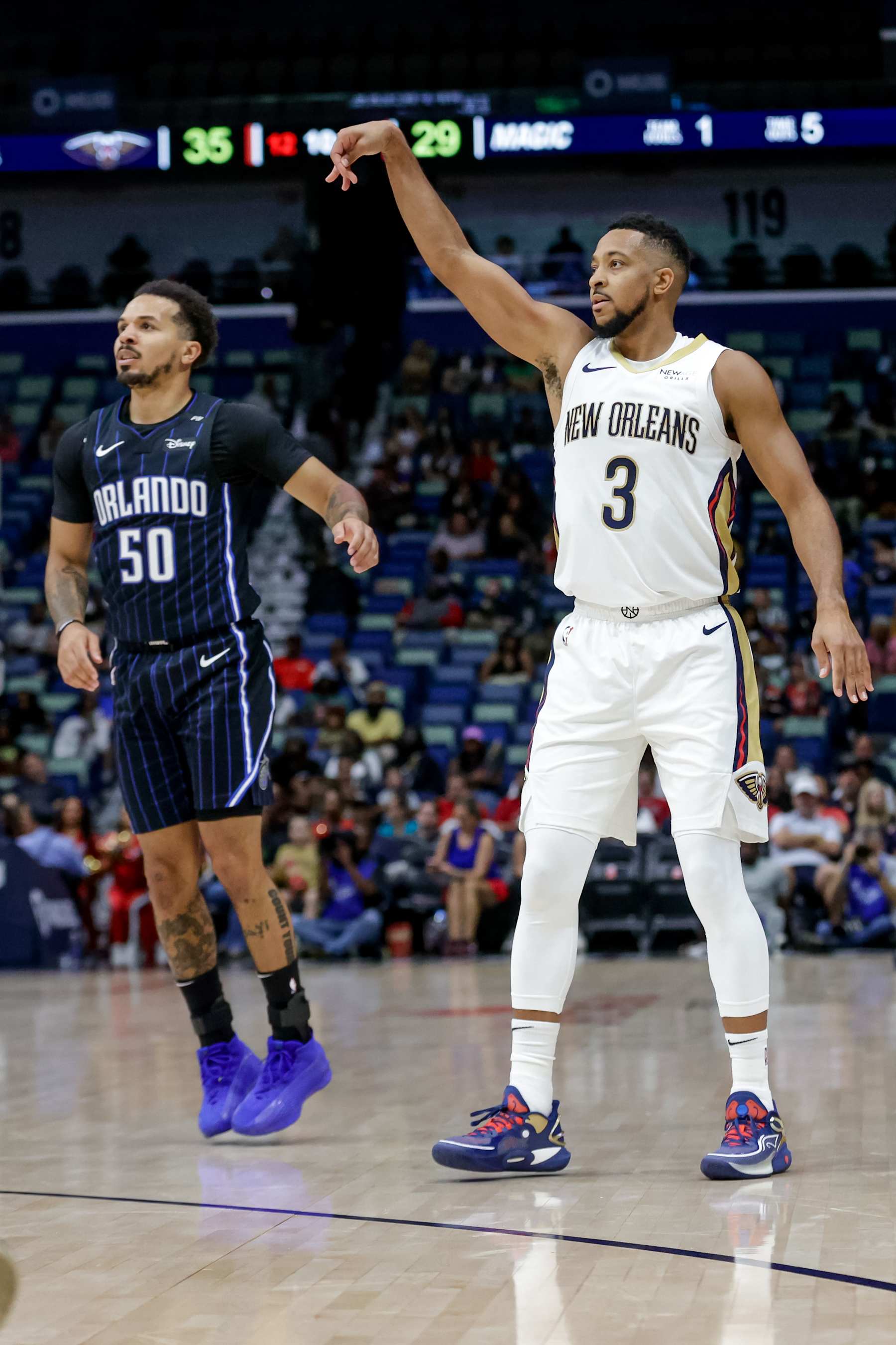 NEW ORLEANS, LOUISIANA - OCTOBER 7:  CJ McCollum #3 of the New Orleans Pelicans reacts after scoring against Cole Anthony #50 of the Orlando Magic during the first half of a preseason game at the Smoothie King Center on October 7, 2024 in New Orleans, Louisiana. NOTE TO USER: User expressly acknowledges and agrees that, by downloading and or using this photograph, User is consenting to the terms and conditions of the Getty Images License Agreement. (Photo by Derick E. Hingle/Getty Images)