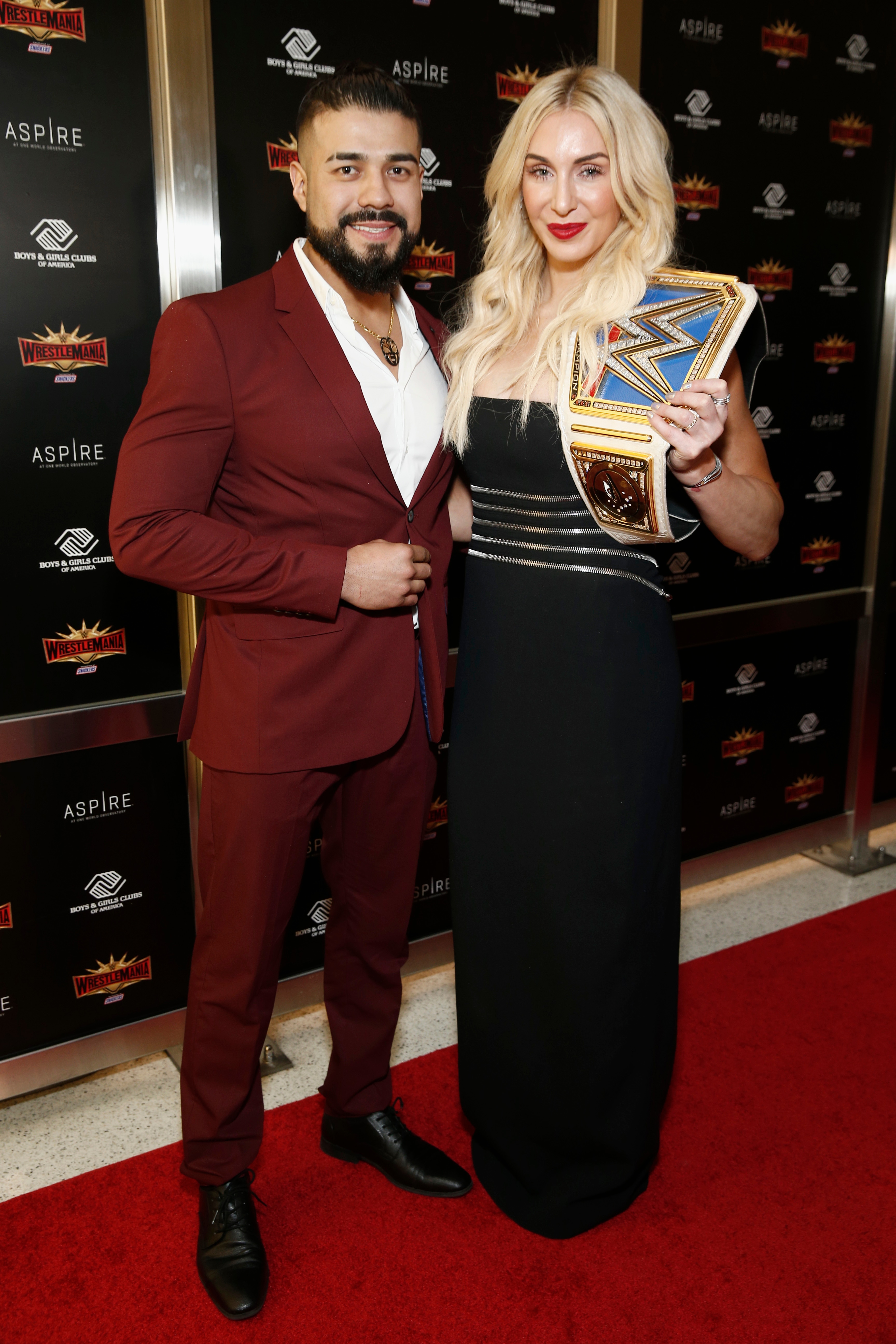 NEW YORK, NEW YORK - APRIL 05: WWE Superstars Andrade and Charlotte Flair attend the WWE Superstars For Hope Reception on April 05, 2019 in New York City. (Photo by Brian Ach/Getty Images for WWE)