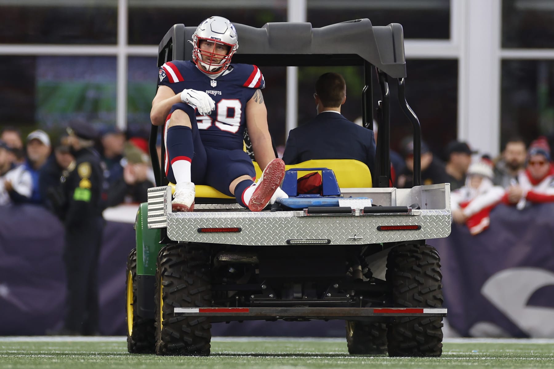 FOXBOROUGH, MASSACHUSETTS - DECEMBER 17: Cole Strange #69 of the New England Patriots reacts while being carted off the field during the second quarter against the Kansas City Chiefs at Gillette Stadium on December 17, 2023 in Foxborough, Massachusetts. (Photo by Sarah Stier/Getty Images)